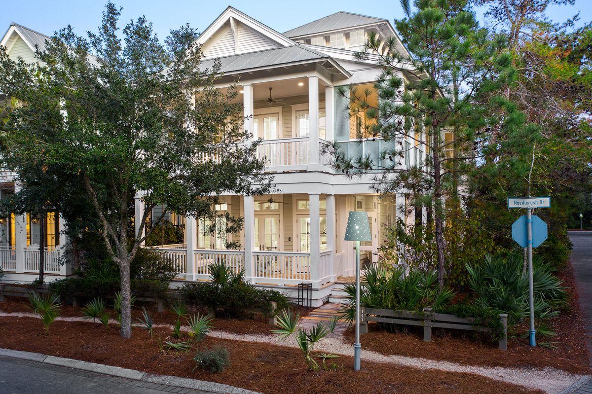 Masterfully designed and primely located in Phase 3 WaterColor, this five bedroom coastal retreat includes an adjoining carriage house and is positioned on a corner lot offering beautiful architectural styling rendered by Chris Stoyles at Archiscapes. Sprawling covered porches and first level living defines this highly functional coastal residence which features an open floor plan with charming covered porches as well as ample space for entertaining. Conveying furnished with beautiful coastal decor, this resplendent home is accentuated by cozy ship-lap wood walls as well as hundred-year-old reclaimed heart of pine flooring throughout. Notable features include an attached carriage house with a full secondary kitchen, living room and bedroom suite with adjoining bath as well as an oversized two car garage with additional open parking spaces. The main floor living layout is prime for entertaining offering an open floor plan, centered around a finely appointed chef's kitchen that boasts premium stainless appliances and anchored by a sizable kitchen island offering ample prep & storage space. The subsequent living/dining area is open to the chef's kitchen and characterized by ample windows offering an abundance of natural lighting overlooking the wrap around porches that offer a welcoming sense of arrival. There are three spacious bedroom suites on the second floor congregated around an open living space, each offering an adjoining bathroom along with 4 bunk spaces. The top level also offers a bunk room (not included in the bedroom count) and additional living space. This property has been maintained as a strict primary / secondary home and has never been offered on a rental program but has exceptional rental potential for a prospective buyer. WaterColor is located in the heart of 30A just north of Seaside and Seagrove Beach. This home is enhanced by the new urbanism lifestyle it offers with close proximity to shops in Seaside town center, the boathouse with direct access to Western Lake, restaurants and local entertainment as well as the white sand beaches and emerald green waters of the Gulf of Mexico.