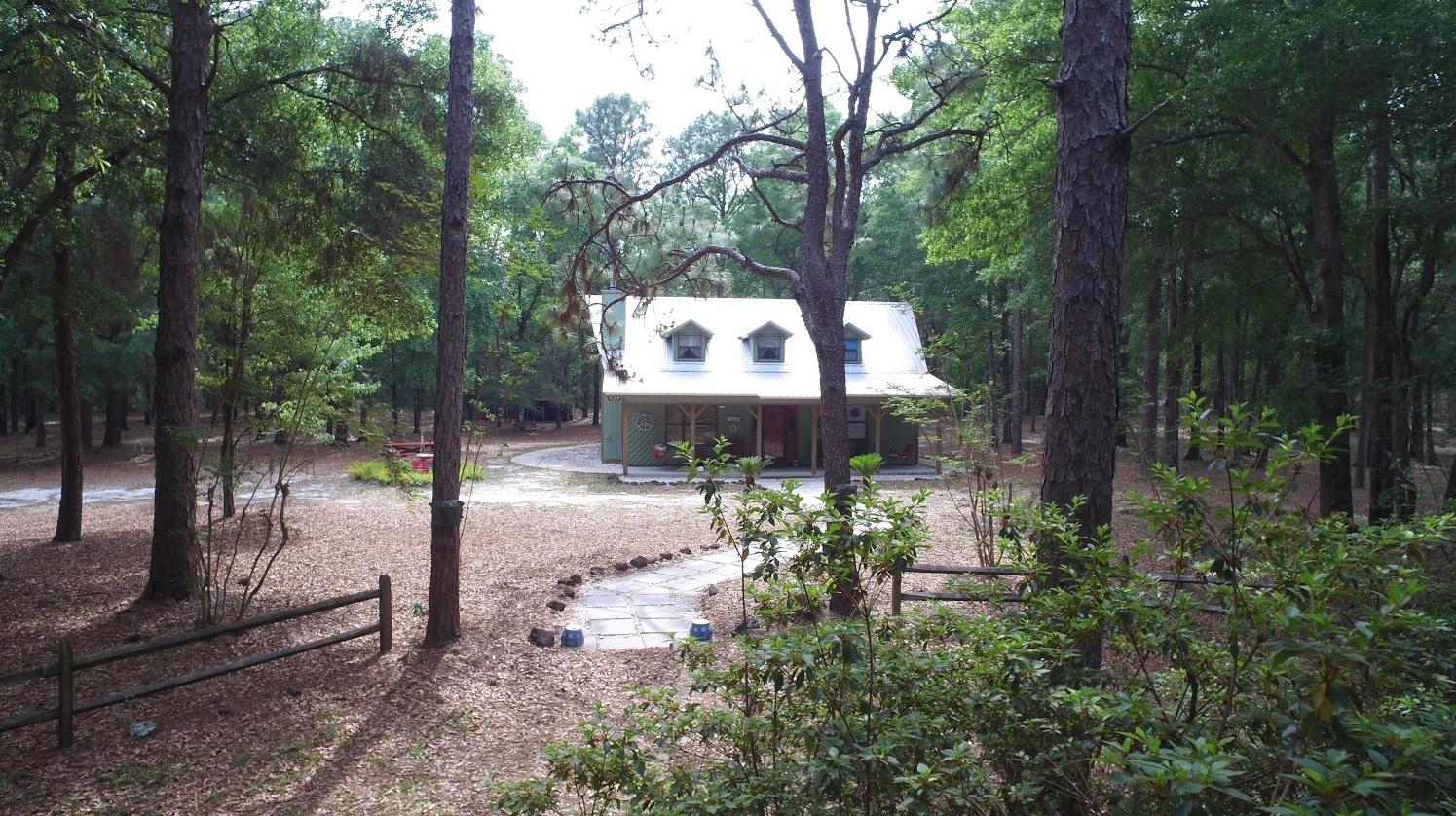 Own your own Country Estate on 8.7 fenced acres within 15 minutes of the sugar-white beaches of South Walton, FL. Easy access to Hwy 331, 20 & 98 plus centrally located near 2 major airports (ECP & VPS). The wooded, park-like setting provides a peaceful and private outdoor environment with future building expansion capabilities! Zoned Estate Residential, the property allows for an additional home to be constructed on 3.8 designated acres of the property. Vaulted ceilings, stunning wood & stone fireplace, open kitchen/dining room concept with custom cabinets and built-in buffet. The current 2400 sq. ft. under roof can be easily expanded another 420 sq. ft. on the homes east side. The charming and welcoming large entry porch provides a great sense of arrival to family members and friends. Recent upgrades have been completed that will give the buyer great "Peace of Mind". The Master Bedroom is located on the 2nd level and the other bedrooms are on the first floor.