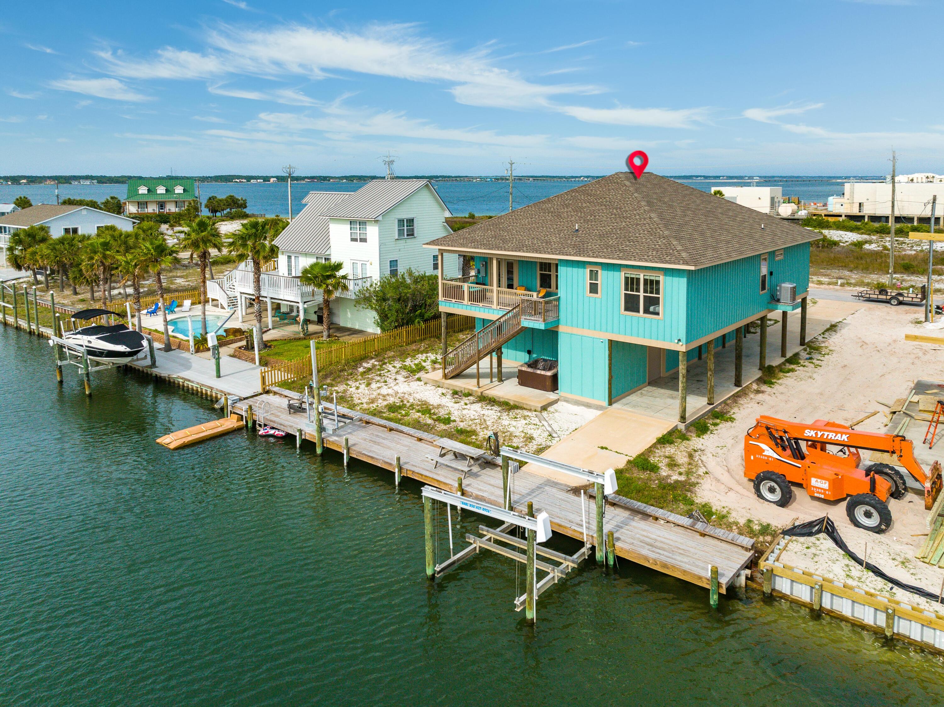 Incredible canal front home with access to the Santa Rosa Sound, a boat lift and no HOA! Being built in 2019, everything in this home is new! Upon entry you'll first notice the 12 foot ceilings in the main living and kitchen area. LVP flooring and crown molding throughout the home. In the kitchen there are top name stainless steel appliances such as Frigidaire. There is a bunk room on the right when you first walk in with plenty of room for additional configurations. To the left you'll find two guest bedrooms and a spacious full bath. In the back of the home there is an additional guest bedroom looking over the canal below and an additional full bath! The master suite is also directly on the canal and has a luxurious ensuite bath featuring dual vanities, separate tub and shower... and a large walk-in closet. On the canal there is a 10,000 pound boat lift as well as a 1,500 pound Jet-ski/PWC lift. This canal leads directly out in to the Santa Rosa Sound which has access to the Gulf of Mexico! This is a great vacation rental property, primary or second home. A boaters dream! The entire ground level of this home is enclosed and has plenty of storage for multiple cars and a Jet-ski or boat! Navarre Beach is one of the last areas with the "Old Florida" appeal and a fantastic place to live and own a piece of paradise as either secondary/investment or primary home. Navarre Beach has miles and miles of white sandy, crowd free beaches and stunning emerald hued waters.