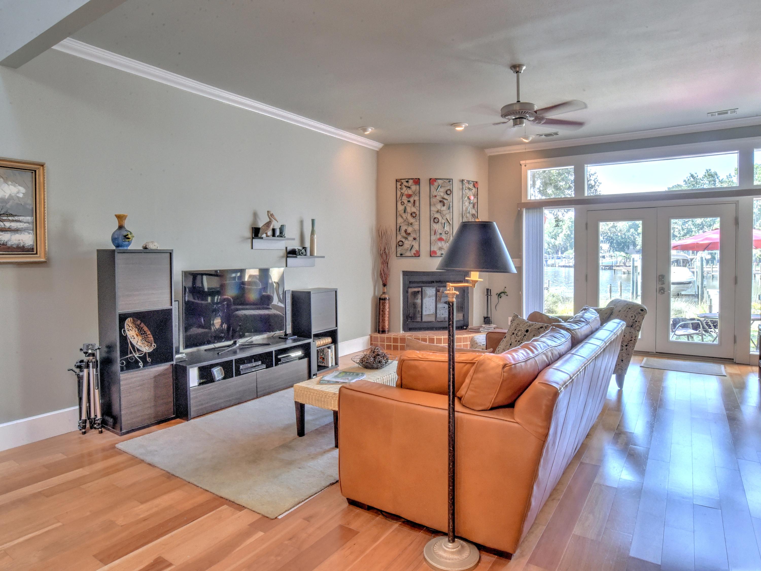 When was the last time you found a fabulous townhome on deep water with a 6,000-pound boat lift. Here it is! Delight from the moment you open the front door! This unit was totally renovated from the walls and floors in! Beautiful wood floors throughout. Very open living concept with fireplace and features a stunning new kitchen with a wow factor. There is still an opening that is sized for a wine refrigerator if so desired. The laundry area features cabinets over the washer/dryer. The doors and trim throughout the unit are stunning. Up the lovely staircase you will find a unique landing that is also open to downstairs. The large master bedroom features a walk-in closet and a wonderful view of the bayou and a balcony. The master bath is the perfect size with a granite double vanity, plenty of cabinets, seamless large shower and a view of the bayou also.  The guest room also has its own lovely bath and a walk-in closet.  There are two outside storage closets.  Step out onto the patio to watch a blue heron flying by or take a slow boat ride on the bayou.  Life just doesn't get any better than this! Seller is providing a home warranty.  All room dimensions to be verified by buyer. (Make sure to view the video)
