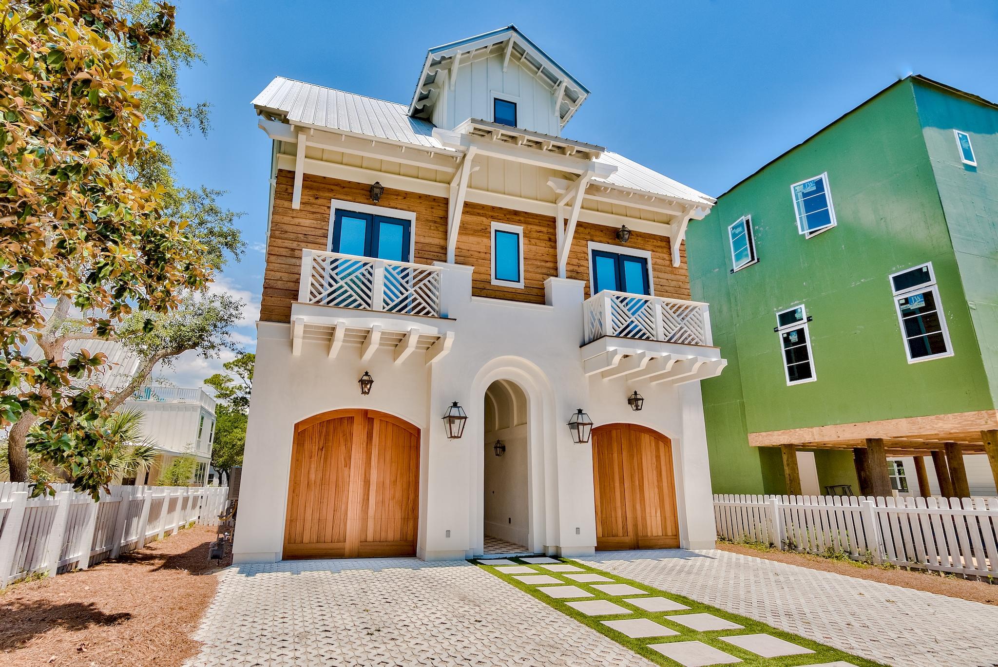 This luxurious, beach estate is located in the  sought after location of Grayton Beach. It's upscale sophistication is perfect for those searching for the ultimate beach lifestyle.  The charm of this gorgeous estate is the privacy and space it offers. The uniquely  designed pool has great views of the coastal dune lake.ordinates with the fun lighting and cabinet pulls. This home has 6 bedrooms, a bunk room, 5 1/2 baths, an elevator, custom 2 1/4'' inch thick interior doors, hardwood floors, rough cut scalloped edge shiplap stairwell, 2 car garage, outdoor shower and a well appointed laundry room. Second and third floor master suites each offer plenty of space ,large walk in closet, balconies with views, and master baths with gorgeous dolomite marble. This homes pristine white architecture, contrasting cedar accent siding, and beautifully designed driveway is just many one of a kind features. The beautiful Grayton Beach, coastal dune lake and the famous Red Bar restaurant is just a short stroll away. Enjoy lake and Gulf views from the expansive balconies or entertain on your back yard in the largest heated pool in Grayton. The barrel vestibule and its French encaustic cement tiles invite you to open the custom designed, locally crafted, arched mahogany front door. The beautiful fireplace and beams that span the entire living room ceiling are encrusted with oyster shells from North Carolina. The gold cubic aluminum backsplash can't be missed as the masterpiece backsplash at the wet bar. This beach estate will not disappoint. Perfect for your home away from home or a luxury vacation rental.