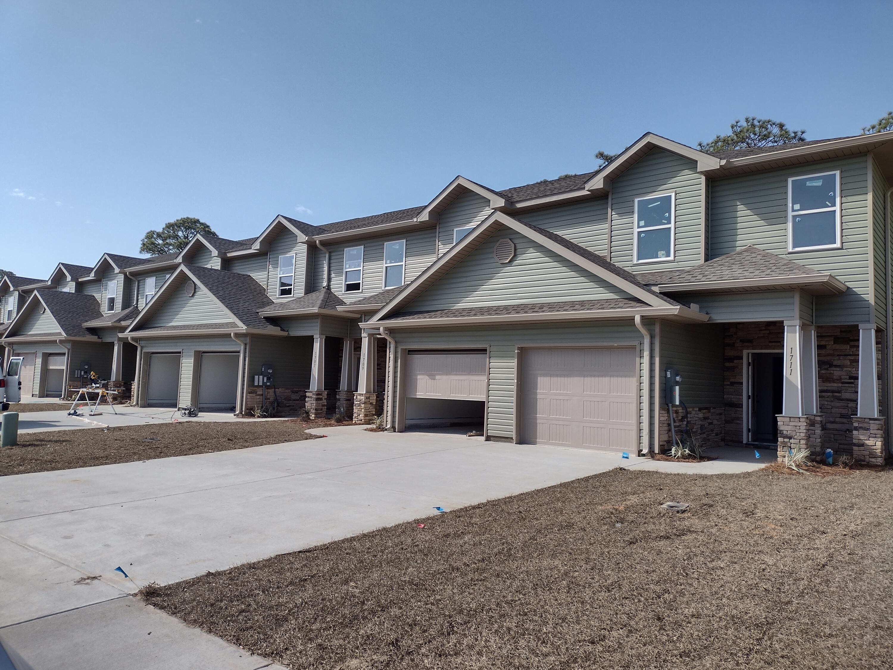 The final 15 units!! 1724 is an interior unit in this Luxury craftsman style townhome community. Built to the latest building and energy codes helps both on insurance as well as power bills. The location is a short distance to Hurlburt, as well as Gulf Breeze. Navarre Beach and Pensacola Beach are short drives as are shopping, and dining options. The home features 3 well sized bedrooms, 2 full bathrooms and a powder room is located conveniently on the main floor. The main floor features an open floor plan. The kitchen features granite countertops, and stainless appliances. Luxury vinyl plank flooring is throughout the home, so cleanup is easy. Upstairs the master suite is located to the back of the home with large walk in closet and double sink vanity. Completion estimated to be Jan 202