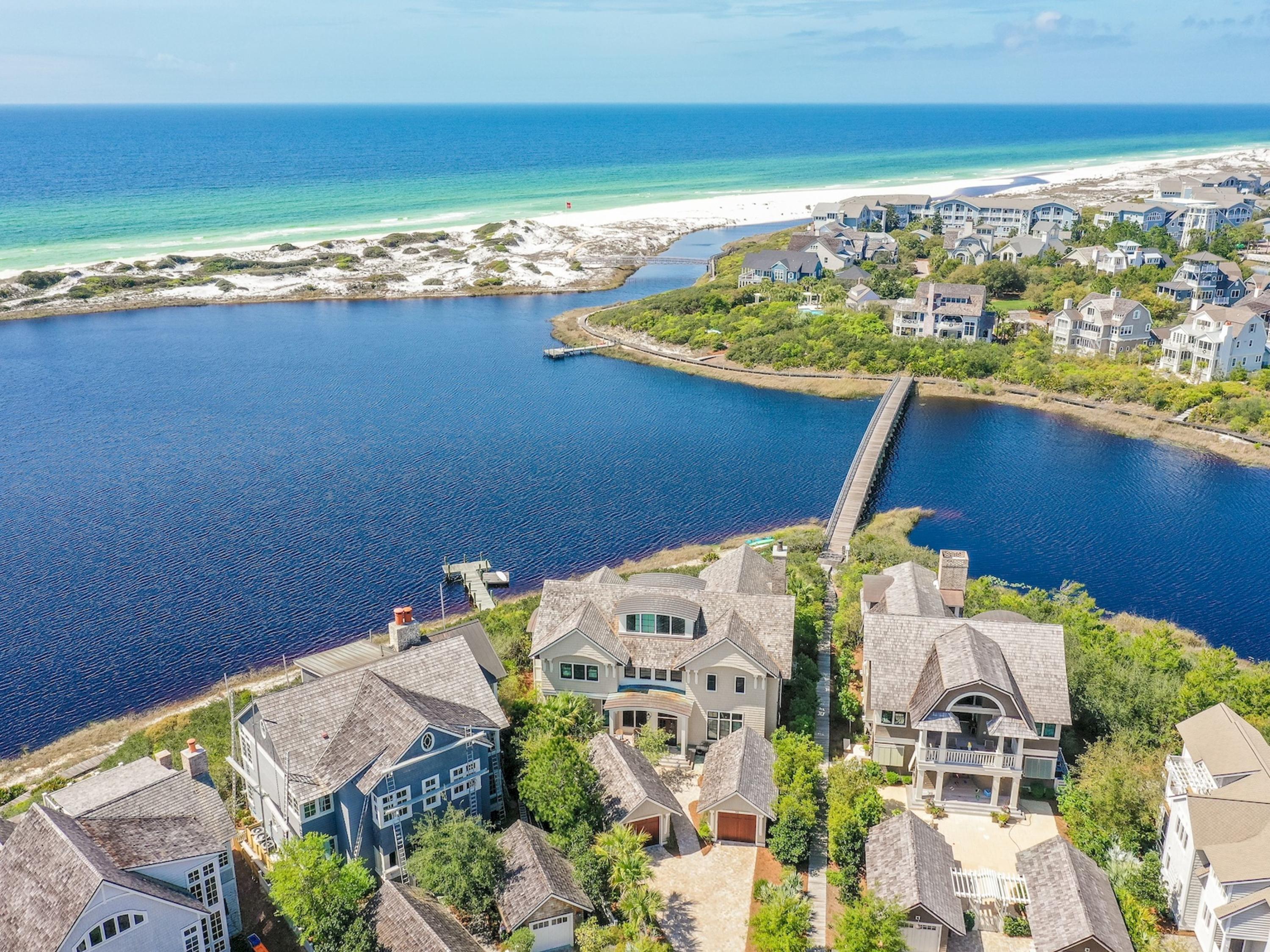 Panoramic Gulf and Lake views abound from this waterfront ''corner'' of Watersound's preferred Peninsula location. This luxurious residence of grand & gracious spaces plays host to captivating views of undisturbed sand dunes and the emerald waters of the Gulf of Mexico! And all to be enjoyed from the privacy of the heated spa/pool and outdoor living room with fireplace adjacent to a well equipped Summer Kitchen. The phenomenal location is a prelude to the masterful design and quality construction of this 3 story abode offering 5 bedrooms/6 Baths. Level 1 hosts 4 guest bedrooms with en suite baths with access to the resort style Courtyard. Level 2 boasts open living spaces with a large chef and prep kitchen, indoor/ outdoor dining areas, expansive living room and master bedroom retreat. Automated porch screens, cypress ceilings and hand-crafted iron railings are a sample of the features that make this home special. Greet each morning from the fabulous master suite with sweeping views of the lake and gulf and pamper yourself in the spa-like master bath with heated floors. Level 3 provides a flex space ideal for a home office or exercise area with a spectacular view and outdoor porch. No detail has been overlooked as this home also offers a private elevator, 2-car garage with extra storage, a second laundry area in the master closet and fine finishes throughout. The Watersound Community delights in a plethora of nature preserves for kayaking and paddle boarding, miles of Boardwalks for strolling and swimming in several private community pools as well as access to a vast expanse of unspoiled Beaches.