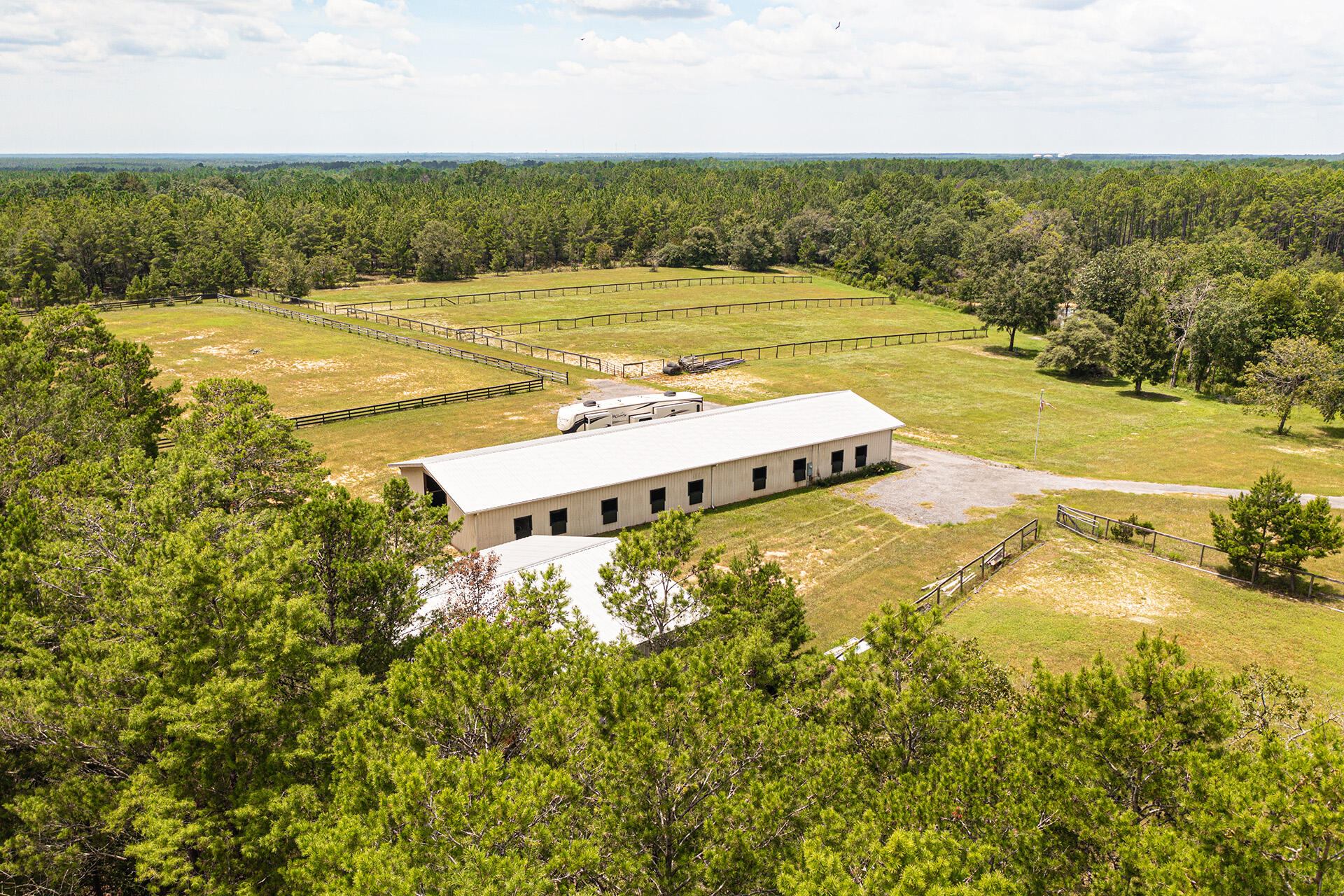 Space for the family or business, Land that most dream of.  Equestrian Ranch that envelopes 21 beautiful acres. The 120' x 36' stable showcases 15 stalls, tack room,  office space, half bath & private security camera/tack room. A 40' x 40' Hay barn, closed in for protecting large equipment, house trailers or RV Storage. A 100'x300' training arena adjacent South of the stable as well as 5 paddocks. Property includes 2 wells, new pump houses, 2 septic tanks & 2 separate entrances. This ideal location offers the option for you to create your dream home's. Choose the East corner or West corner overlooking the Ranch & Beautiful Pond.The natural, spring fed pond sits center of the property & back adjoins the Wildlife Conservation preserve. Designed for Horse enthusiast but multiple investment .