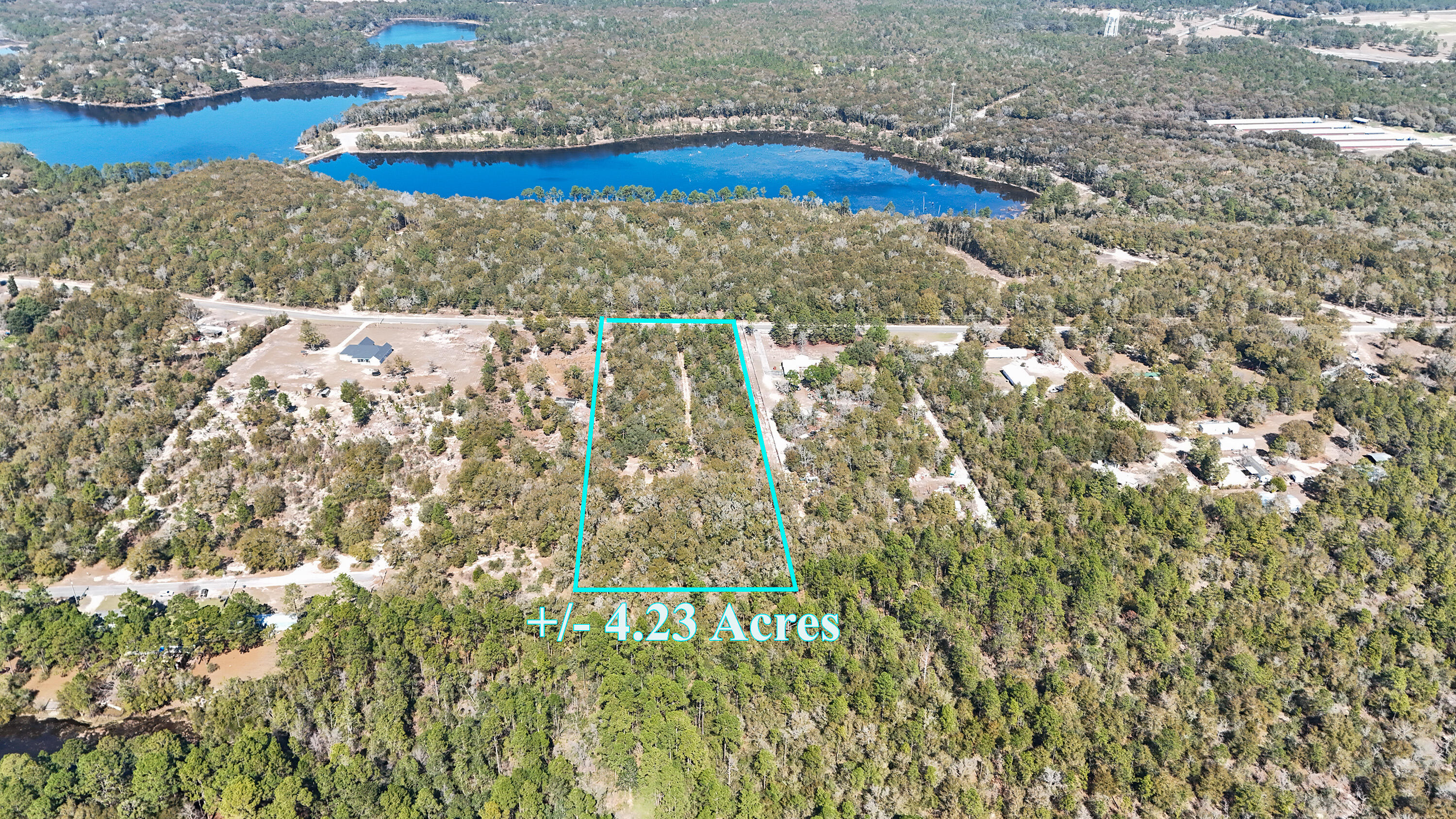 4.23 acres, private homesite already carved out under gorgeous mature oaks, and you can't see it from the road. Follow the drive back to a level, park-like clearing ready for your build. Temporary power pole is in place. Existing well present but not warranted; city water available at the road with tap fees due. Rural Village zoning allows manufactured homes and up to TWO UNITS PER ACRE, perfect for homestead plans, multi-generational living, or income potential. Quiet country feel just 5 minutes north of downtown DeFuniak Springs. Bring the plans, the animals, or the family - or all three!
