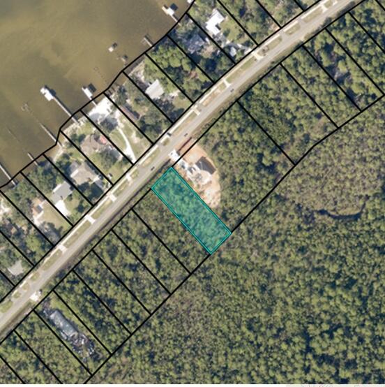 Wake Up to Water Views: Build Your Dream on the Edge of Paradise!  Imagine warm breezes whisper through as you sip coffee on your balcony, gazing across the shimmering expanse of East Bay. This incredible lot in the Lagniappe Beach area, nestled on the border of Gulf Breeze and Navarre is minutes from Navarre Beach: Sink your toes into sugar-white sand on the Gulf of Mexico, just a short drive away.  Build Your Vision:  No HOA restrictions so design your dream home as you please. Zoned Residential: Ideal for families, retirees, or anyone seeking a large 100x300 foot water view lot.  Utilities at your fingertips: Water, electric, and cable connections are readily available.  This is more than just a lot; it's an opportunity to live the life you have always dreamed of.
