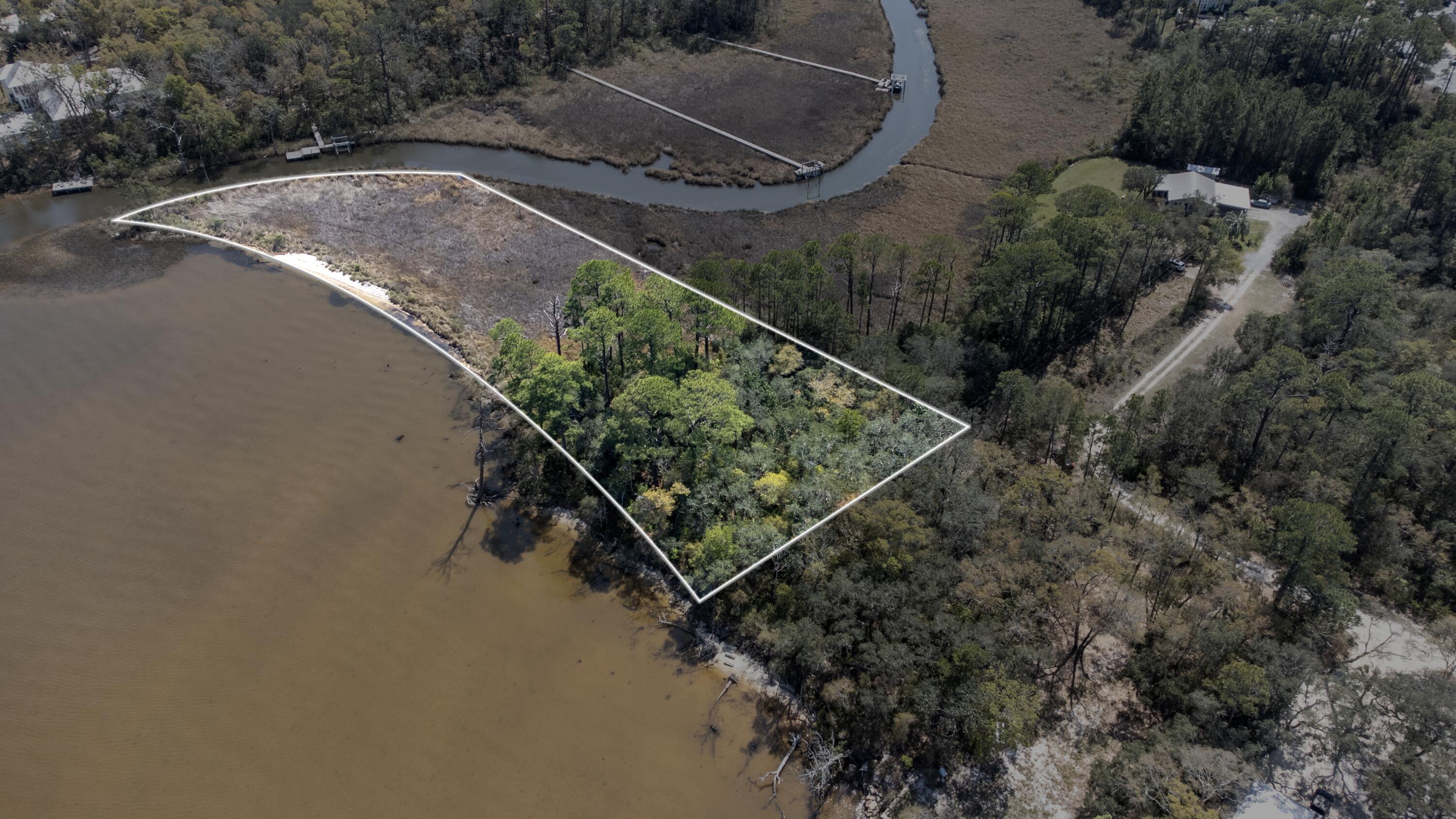 1 of 4 lots available. Don't miss this rare chance to own a bayou front homesite in the serene Santa Rosa Beach, nestled within the Rosestar Subdivision off Bay Magnolia Lane. This stunning waterfront property spans 2.29 acres and allows for private boat slips, perfect for boating, kayaking, fishing, and fully embracing the coastal lifestyle right from your backyard. Situated on a private road with no HOA, you will enjoy the freedom to design and build with fewer restrictions. Up to 40% of the wetlands may be built upon, offering flexibility for future development while preserving the natural beauty of the surroundings. The Development Order is currently in progress and anticipated for completion in early June 2026, making this an ideal time to secure your piece o waterfront paradise. Over 36,000 square feet of buildable land.