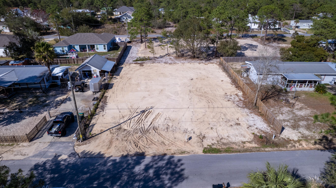What a great opportunity to buy a cleared, quarter acre lot ready for your dream home! Right down the street from Walmart, First Watch, and The Donut Hole. Less than 3 miles to Grand Boulevard and only 1.4 miles to the west entrance of 30A. No HOA and located in Flood Zone X (No flood insurance required). Public sewer and water are available.  If you are looking for a great location on a tranquil dead-end street, you have found it!