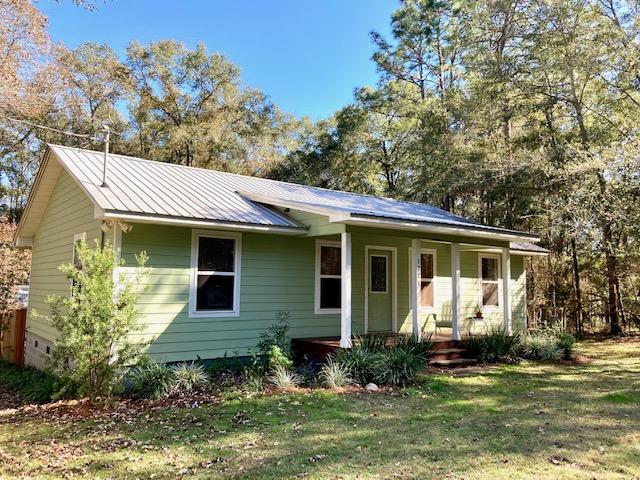 CHARMING COUNTRY HOME WITH ACREAGE -- Enjoy the quiet country life only 12 miles east of DeFuniak Springs! This 2BR 1 BA home on 2.8 acres is perfect for a couple or small family who wants room to roam.  House features stainless appliances, breakfast bar, carpet & tile flooring, cement board siding, and a metal roof.  Outside there's a large deck with built-in seating and a covered area for grilling. The deck overlooks a fenced back yard for your pets, and a nice shop with metal roof, plywood floor, electric & available water.  Circular driveway runs past a carport with room for a boat, mower, etc.  Property is only 30 minutes from our white sand Gulf beaches and close to several natural springs and rivers for swimming & fishing. Grab your little piece of paradise -- it won't last long!