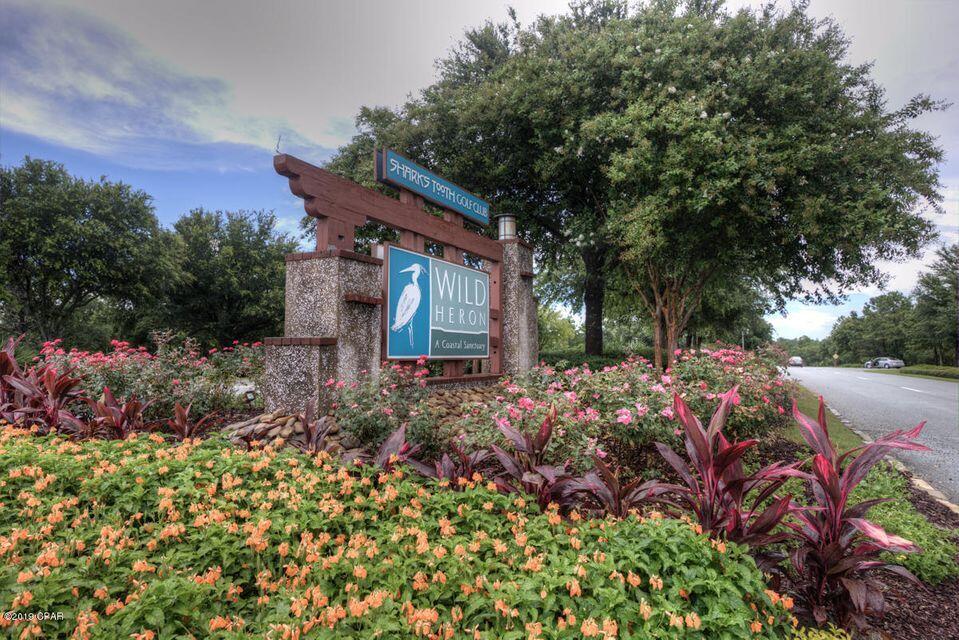 This large lot located with APPROVED PLANS on a cul-de-sac has approved building and landscaper plans to build your Dream Home.There is a conservative easement behind the lot which gives you a little more privacy.   Wild Heron a 734 acre coastal sanctuary, is a gated community, on the shores of Lake Powell. The amenities include a workout facility,  pool with hot tub,  fire pit, dock  on  Lake Powell , playground, kayaks, boathouse with a covered pavilion, an event lawn  and hiking trails. WH is the homes of Greg Norman's Shark's Tooth Golf Course. Close  to all the Beautiful Beaches, dining and shopping but far enough away from the noise. Golf and tennis requires an extra membership. If dimensions are important please verify.CDD is $2221.91. New Owner will need to resubmitt plans to ARB