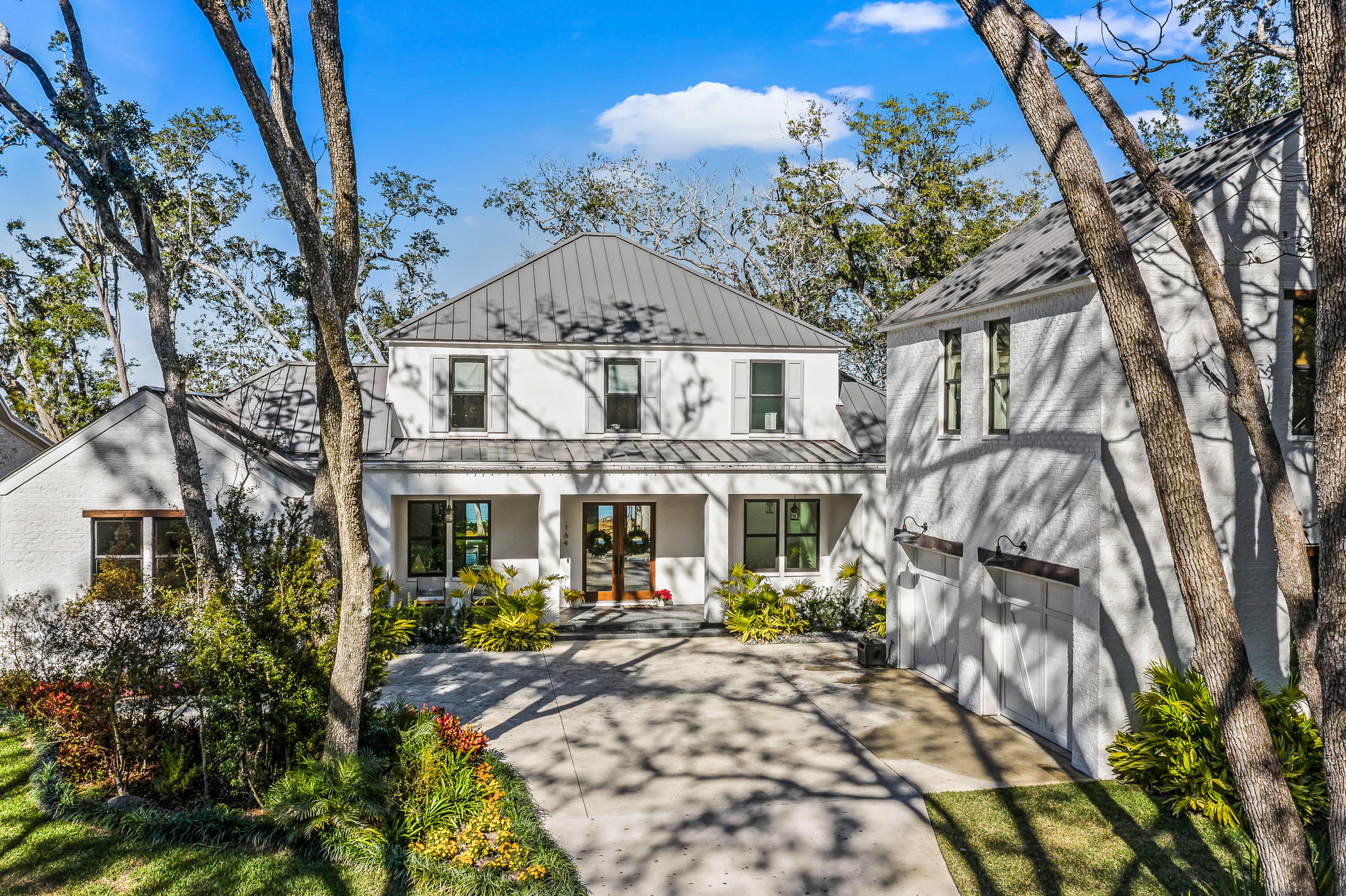 Enjoy all that bay-front living has to offer from this beautifully constructed home in Point Washington. The Woods neighborhood offers a peaceful escape with world class boating all just minutes from the beaches that have made 30A famous. The gorgeously landscaped .7 acre property is the perfect place to call home. Upon entering you are greeted with expansive bay views through the open living area complete with a fireplace. The first floor has direct access to the large pool (with an electric pool cover for kids and pets) and backyard area. The spacious kitchen with quartzite countertops and a Wolf gas range leads to a screened in porch with an outdoor grill and sink. White oak floors can be found throughout the home. You will also find a butler's pantry, half bath, and laundry room behind the kitchen area. The master bedroom is on the first floor and also has amazing water views and a private screened in porch. The master bath has a soaking tub, double vanities, shower and large his and hers closets. There is an additional sitting room on the first floor that could also be an office. On the second level you will find a separate living space/ playroom. There are two bedrooms with a large jack and jill bathroom. There is also an additional bedroom and bathroom with spectacular views of the Choctawhatchee Bay from the second floor. Above the large two car garage is the separate mother-in-law suite that can be locked out or accessed from the main home. It has everything you need with a living room, bedroom, kitchenette, laundry and full bath.