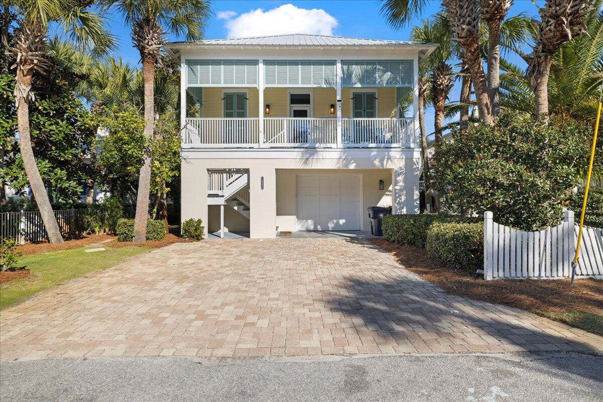 (Back on the market, no fault of the Seller!) Step into effortless coastal living with this beautifully designed two-story home offering 5 bedrooms and 4 bathrooms -- plenty of room for family, friends, or guests. Thoughtfully designed as two distinct living spaces, each level features its own private entrance, full kitchen, and inviting entertaining areas, offering flexibility for multi-generational living, hosting, or rental potential. 

Excellent income-producing opportunity for investors or owner-occupants -- intentionally set up to function as separate living areas across both floors. In 2025, it generated over $88,000 in rental income! 

The golf cart is included - with easy access to the community pool and within walking distance to the beach!