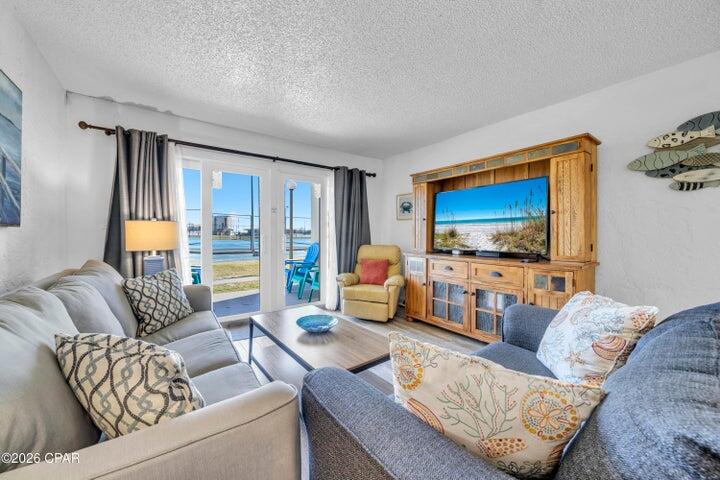 Fantastic offering at Sugar Beach condo, a gulf front development on Thomas Dr! This perfect condo offers a rare combination of space, accessibility, and direct beach access. With 1,086 square feet, two bedrooms, and two full baths, the layout is well suited for a primary residence, second home, or investment property. Positioned on the ground level, the unit provides easy indoor-to-outdoor living with quick access to the beach—no elevators, no stairs, just steps to the sand. Inside, the open-concept living and dining area is designed for comfort and functionality, while large windows bring in abundant natural light.