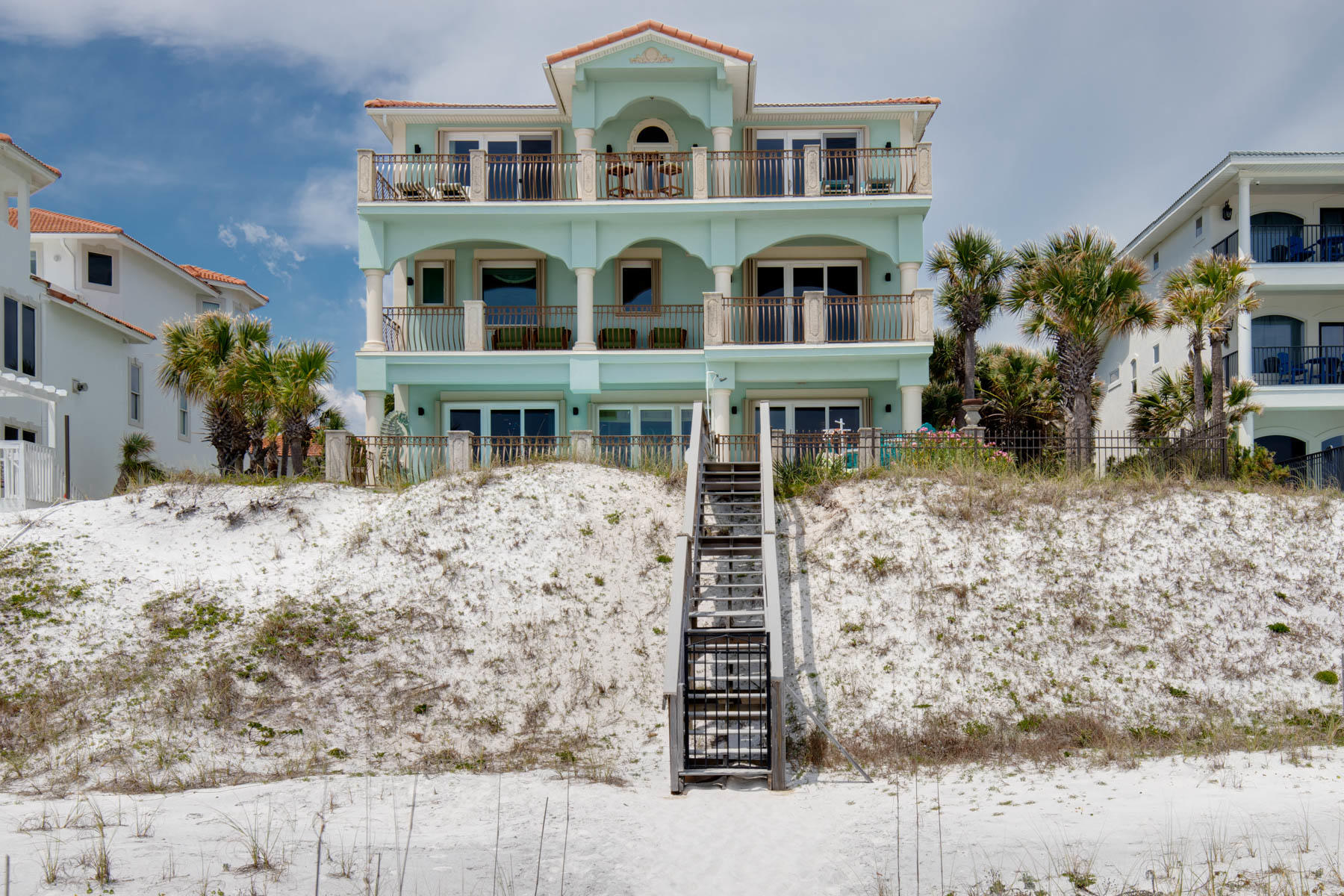 Just Reduced 150k. Casa De Palmas is one of the most exquisite custom beach front homes in Destin. Ideally located in Crystal Beach, and set on 67' of beachfront, this could very well be your families perfect beach house! You first enter a courtyard shaded by palm trees, and are immediately greeted by an impressive grand entrance staircase with cast stone columns and balustrades. The custom Walnut door is surrounded by a beautiful stained glass window installation that was made for this home. As you enter you're met by ocean views, but as you look closer you'll notice the comfortable and inviting floor plan, with MANY recent upgrades. There are Pecky Cypress ceilings in the main living areas and bedrooms, and a mixture of hardwood and stone floors. The kitchen is a show piece with Vetrazzo Sea Glass countertops and hand blown glass chandeliers that perfectly capture the colors of the waters just outside the sliding glass doors. The kitchen also features a Cobalt Blue 8 burner Viking Range, 3 ovens, and a GE Monogram refrigerator ready to tackle any dinner party, and the "Coastal Grey" Kraftmade cabinets that tie everything together. There is also a large walk in pantry and locking wine room with a kegerator. Decorated with a "Beach Chic" flair, Casa de Palmas is a masterpiece you need to see! The living room features a gas fireplace, custom shelving, and on the wet bar where you'll notice the first of the many hand painted murals in the home. This fantastic floor plan with an emphasis on Gulf views has been the owners primary residence for the past 3 years, but was recently put on rental and immediately became one of the most popular gulf front rentals in Destin. It's easy to understand why. No detail was overlooked in the remodel of this home! On the second level, you'll find the ''Captain's Quarters'', a spacious master suite with a gulf front balcony that spans the width of the home, a gas fireplace, two walk-in closets and a large master bath with 2 water closets, separate walk-in shower and raised Jacuzzi tub overlooking the Gulf. Adjacent to the Captain's Quarters is a locking owners closet. The second floor also has the ''Flamingo'' guest suite, with its own private bath. On the third floor is the ''Manatee'' guest suite and the ''Pirate'' guest suite, another wet bar and a large balcony. All floors are accessed by an elevator. The first of the 2 guest houses is atop the double garage, and is complete with a living area, kitchen, washer and dryer, large bedroom, full bath, and balcony with gulf views. The 2nd guest house is atop the 3 car garage and is nearly 700sqft with a large living room, a kitchen that has been plumbed for a gas cooktop, a dining area, and a large bedroom with a walking closet, and a washer and dryer. This home is sold fully furnished and on rental a rental program projected to top $350,000 a year.