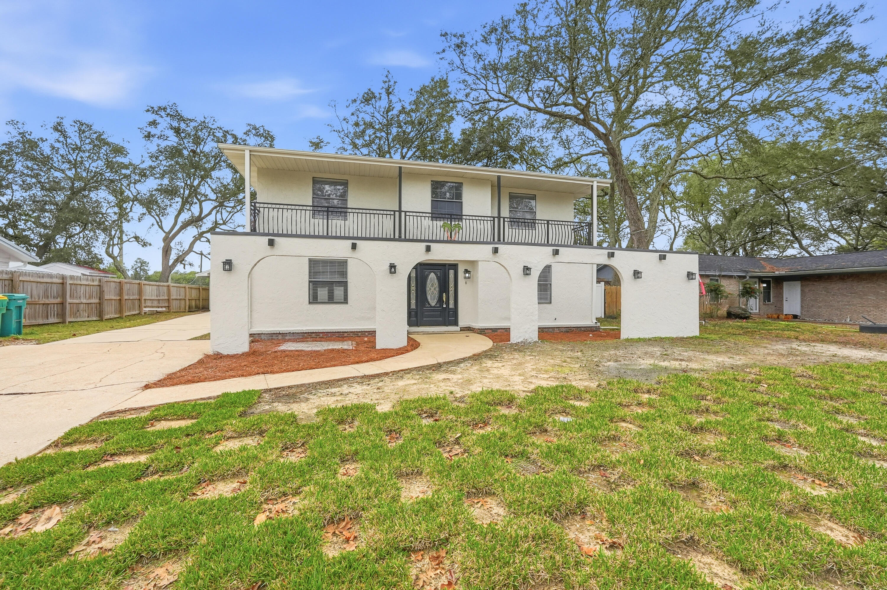 ***5 BR rentals are hard to find...especially with these beautiful updates!!*** Welcome home to this spacious five-bedroom, three-bath Mediterranean-style residence on a massive private lot in the heart of Niceville. Designed for both everyday comfort and convenient living, this two-story home has a spacious floor plan and short commutes to all that Niceville has to offer. Inside, the front entry is finished in timeless tile, while the formal dining room showcases real hardwood floors and a striking brick-enclosed wood-burning fireplace that adds warmth and character. Natural light fills the home, highlighting the open living areas and inviting sitting room. The eat-in kitchen is thoughtfully appointed with maple cabinetry, stone countertops, stylish stainless steel appliances, and ample space for casual dining. The first floor features a convenient bedroom, laundry room, and additional bathideal for guests or multi-generational living. Upstairs, the primary suite is a true retreat, complete with its own brick-surround fireplace, dual vanities, a tiled walk-in shower, separate water closet, walk-in closet, and linen storage. Additional upstairs bedrooms are generously sized and share a full bath with a shower-tub combination, large vanity, and ceiling fans, all bathed in natural light. A detached garage/large utility shed provide excellent storage and flexibility. With its thoughtful layout, classic finishes, and exceptional outdoor living spaces, this home offers comfort, style, and versatility in a desirable Niceville setting. Contact us today for your showing!!