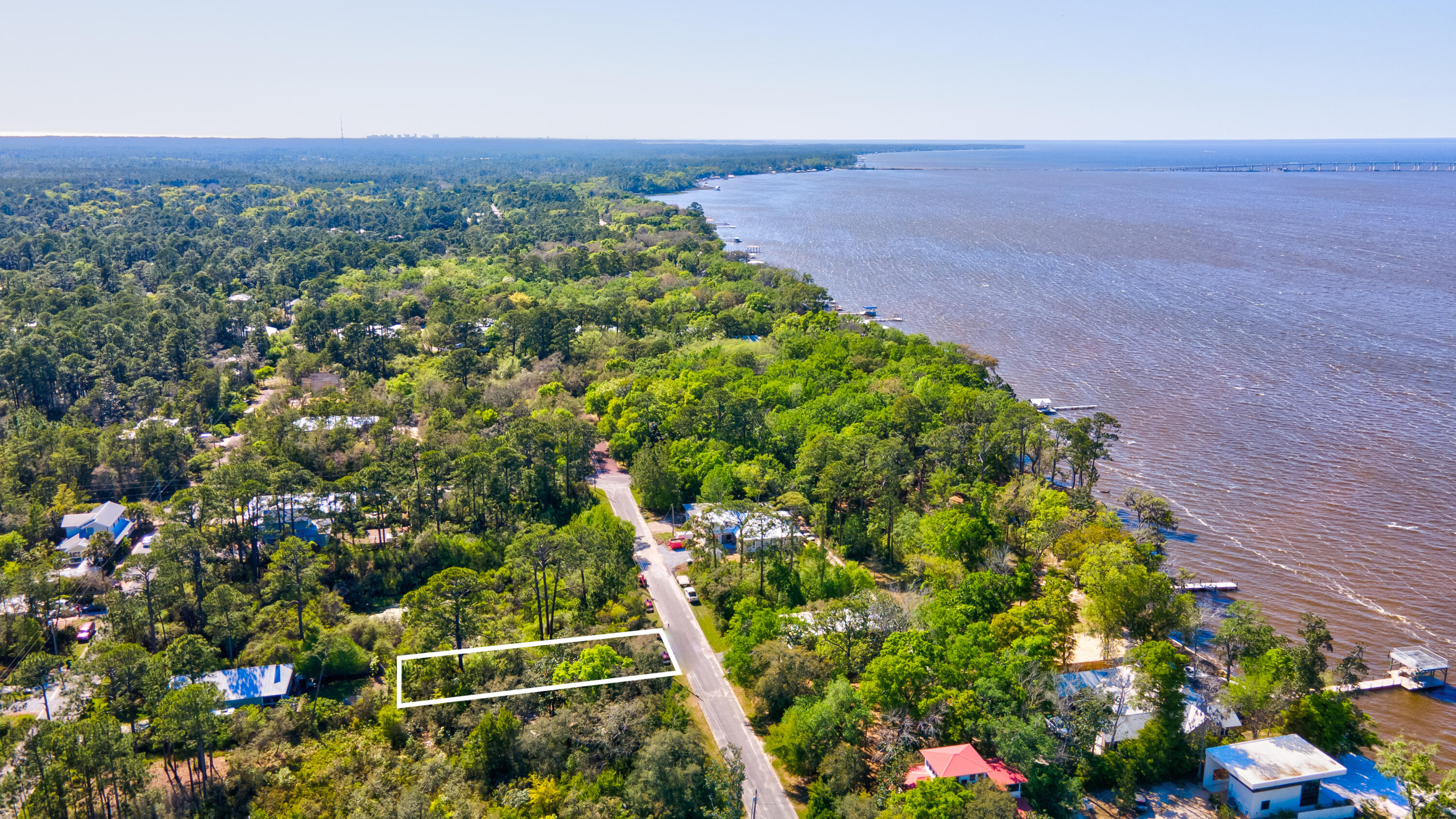 Wooded lot available in Desirable Magnolia Beach Bayfront Community.  Looking north from lot you can see views of the Bay. Silverleaf Lane is a paved road. Nearby Bayside Ranchettes Park offers shaded parking, picnic tables, fishing dock and Kayak/canoe launch on East Mitchell Avenue.  Tom's Marina offers boat slips- be on the Bay in minutes.   Grayton Beach State Park approximately 4 miles away.  Point Washington State Forest borders Highway 283 and bike paths head south to Grayton Beach.  Enjoy living in a quiet community yet restaurants, shops, 30A, beaches and Gulf of Mexico just minutes away.