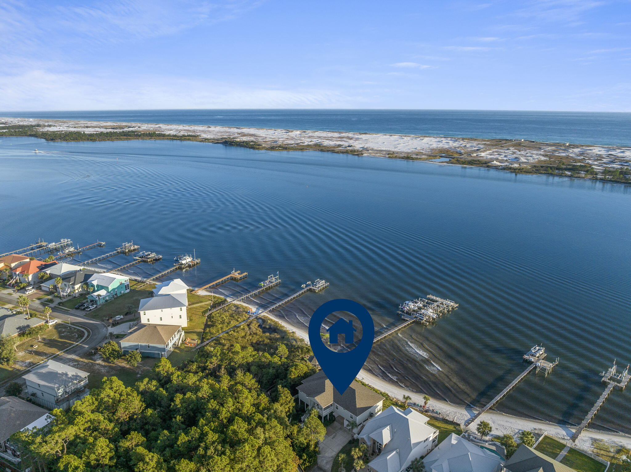 Immerse yourself in luxury and tranquility with this 4-bedroom, 3.5-bathroom custom-built residence, nestled in the coveted Sparkling Waters neighborhood on the Santa Rosa Sound.  Included is a deeded boat slip in the marina, complete with a 10,000 pound lift, that you can see right outside your windows. The impeccable curb appeal invites you into a world of panoramic intercoastal views, expansive living spaces, and unmatched style. Inside, 10-ft high ceilings adorned with striking crown molding harmonize with plank tile flooring throughout, all framed by elegant 5 1/4'' baseboards. The gourmet kitchen is a culinary enthusiast's dream, boasting custom ivory-painted cabinetry, sleek granite countertops, top-tier stainless steel appliances, including an oversized commercial-grade refrigerator/freezer, and a spacious pantry. 

The generously sized waterfront master suite is a haven in itself, featuring dual walk-in closets, a lavish en-suite bathroom with a glass-enclosed walk-in shower, a whirlpool garden tub, and a double vanity. For entertainers, the waterfront living room and dining area seamlessly merge, extending out to a vast covered porch perfect for alfresco moments. This home features waterviews from the Master bedroom, living room, formal dining room, and additional guest bedroom. Practicality complements luxury with features such as a conveniently located laundry room, a meticulously landscaped yard with a privacy fence, a sprinkler system, well, and timer.

The home's waterfront perks are in a league of their own, offering homeowners an island oasis outside. With breathtaking Gulf and Santa Rosa Sound views evident from the balcony and various rooms, the property stands as a testament to superior waterfront living. Residents will also be delighted with the charming private beach, a pristine swimming pool with custom stone decking, and a private stretch of white sugar sand beach. In 2020, the saltwater pool was built with a heater and measures 30x15.  The bonus spacious covered outdoor area, stemming from the finished concrete below, adds to its charm and is perfect for another entertainment space for family and friends just overlooking the water.  

Built on a classic piling foundation, the home's design exudes contemporary flair.  The residence's prime location, a few miles from Destin and just minutes from Navarre Beach, perfectly balances serene beachside living with proximity to lively attractions. In summary, this Sparkling Waters gem is ideal for boating aficionados, entertainers, or those who desire serene moments enveloped by cool sea breezes. Experience unparalleled waterfront elegance. (There is a boat available for purchase in addition to the home, if interested.)