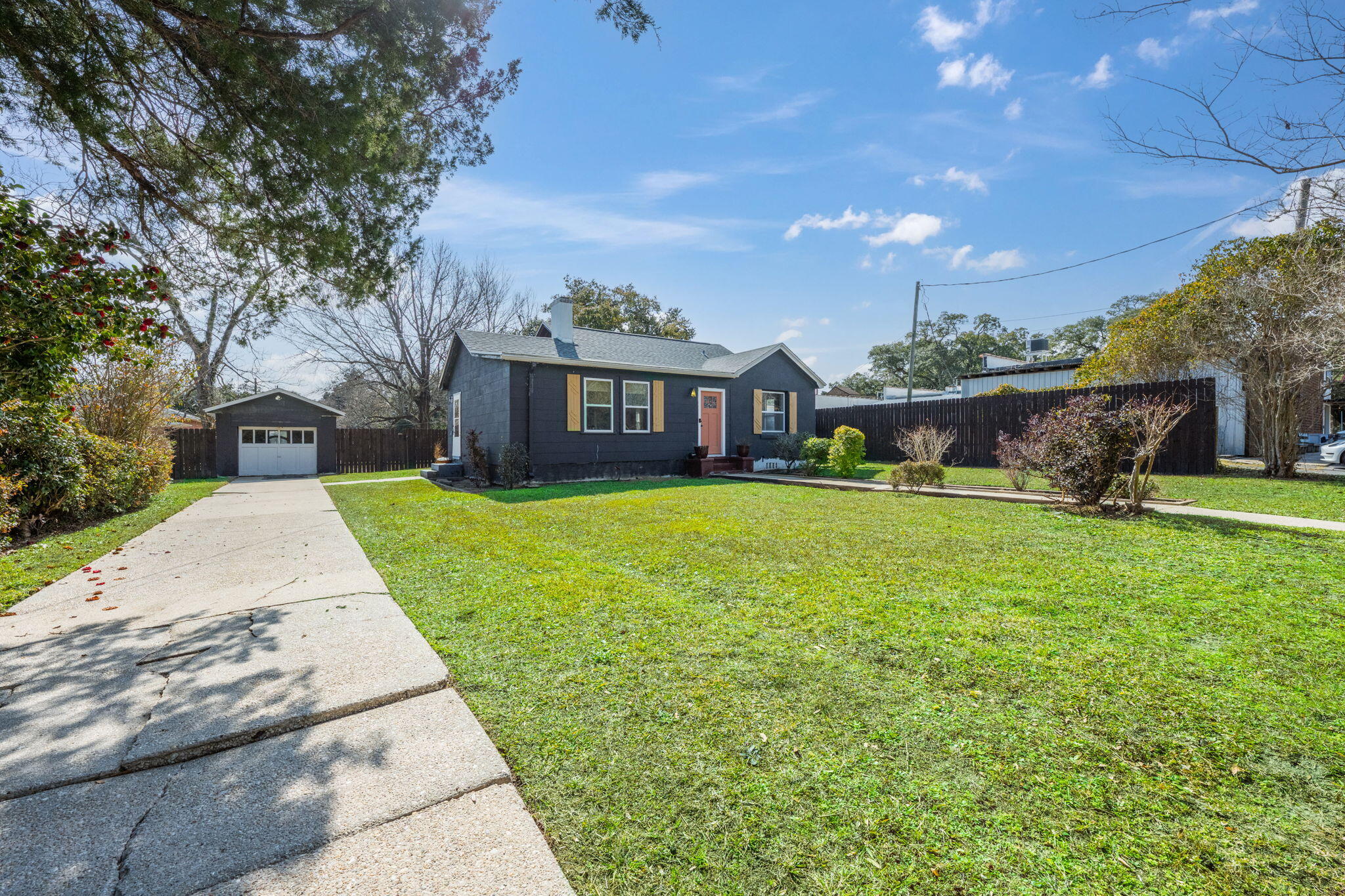 Welcome to this charming 2-bedroom, 1-bathroom home located in the highly desirable East Hill neighborhood. Situated in a walkable area with sidewalks, this home offers the perfect blend of convenience and comfort. Just steps away from local shopping, dining, and other amenities, it's easy to enjoy the best of the city while being nestled in a peaceful and friendly community. Built in 1946, the home exudes character, with beautiful hardwood floors that flow throughout the living spaces. The cozy living room is highlighted by a fireplace, adding a warm and inviting touch. Adjacent to the living room is the kitchen, which features a dining nook with a window that overlooks the expansive backyard—perfect for enjoying your morning coffee or meals with a view of the outdoors. The two bedrooms and bathroom are located down a hallway, offering a sense of privacy. The bathroom includes a tub-shower combo and a single vanity with storage underneath, providing both function and style. The home also boasts a detached garage and a long driveway with ample guest parking, making it easy to entertain or accommodate multiple vehicles. The real gem, however, is the large backyard. It's the ideal space for outdoor activities, gardening, or simply relaxing. Plus, an outdoor shower adds a unique and refreshing touch to this beautiful outdoor space. This home in East Hill offers a perfect opportunity to embrace a desirable lifestyle with a fantastic blend of character, convenience, and outdoor charm. Don't miss the chance to make this charming property your own!
