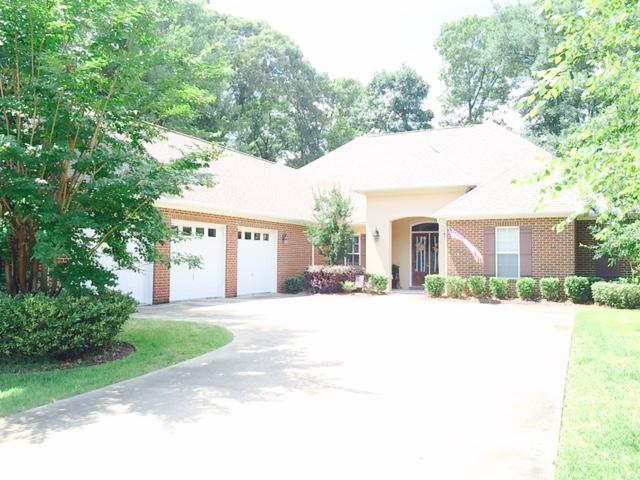 Beautiful custom home in the heart of Claire's Vineyard with many upgrades added. House has 4 bedrooms in 3 separate areas. There is an additional study (not included as bedroom.) Beautiful great room with lots of natural light and fireplace. Many custom built-in cabinetry in the study, great room, kitchen and master closet. Additional fireplace is the master bedroom. A three car garage. Lots of storage above the garage. Ceiling heights are between 10' and 12' throughout the house. Master, dining room and great room have treyed ceilings and crown molding. Beautiful hardwood flooring throughout living area/dining area. Bedrooms all have upgraded carpet. Travertine floors in kitchen and bathrooms. Outside screened in lanai wraps around the back of the house to take full advance of beautiful