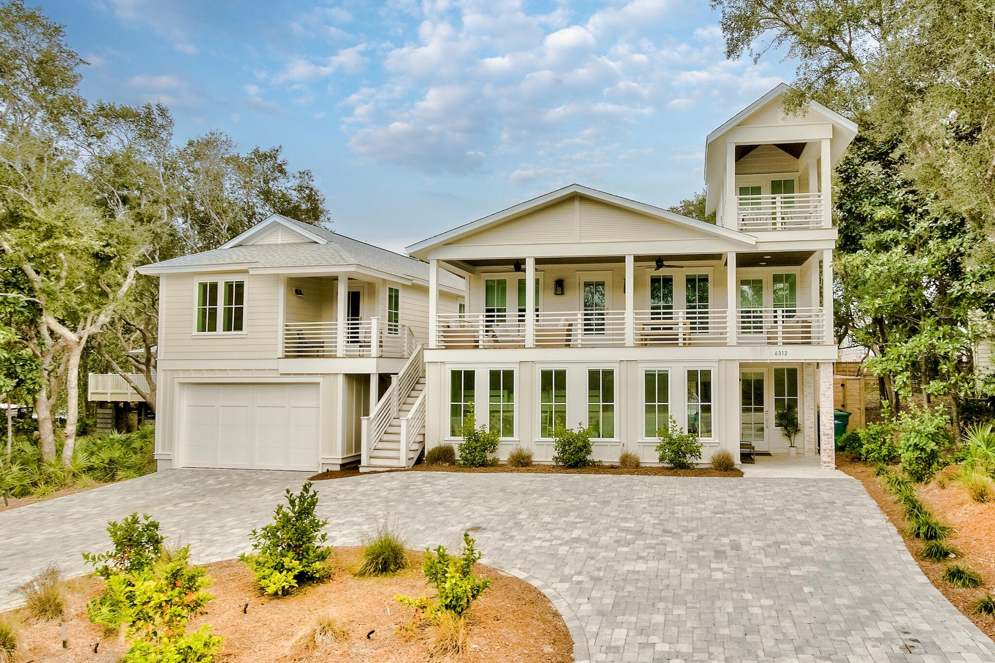 Ideally situated on an extra-large lot with a new, heated resort-style pool, this completely renovated home features a newly constructed oversized garage with carriage house and is only a short stroll to the white sand and emerald waters of the Gulf. Boasting seven bedrooms and seven bathrooms (sleeps 22), attention to detail is abundant throughout. Features include a large, open living space with a chef's kitchen, wood floors, custom trim work, exposed brick, shiplap, marble tile, designer finishes, and beautiful furnishings. The home flows seamlessly to the outdoors, combining exceptional indoor and outdoor living. Listen to the surf from the porch or heated, private pool, and enjoy the large private yard complete with mature oaks and lush landscaping with plenty of room for sunbathing, grilling out, and outdoor activities. There is plenty of parking on the circular driveway or in the oversize garage spanning 44'.

As you enter the ground level, you will find two guest bedrooms with en-suite bathrooms, a large bunk room with custom bunk beds, an additional bathroom, a large laundry room, and a recreation room. The recreation room opens up to a large backyard oasis offering a spectacular heated pool and patio, grilling area, and open-air shower, all waiting for you to unwind after a day at the beach. The grand staircase will lead you to the second-level great room with vaulted ceilings, dining room, and a well-appointed kitchen complete with a large gas range and large island. Also, on this level, you will discover the master suite and an additional guest suite. A large covered front porch just off the living and dining area overlooks Hwy 30A. The home's second level also offers access to the relaxing viewing tower.
 
 The newly constructed carriage house compliments this beachside manor, featuring a fully equipped kitchen, spacious living room, two bedrooms, and two bathrooms. The private master suite overlooks the heated pool with a private balcony. In addition, the expansive garage with finished walls, recess lighting, and laundry hookups offers space for a gaming area and plenty of storage for all your beach gear, bikes, and games to enjoy your stay!
 
After a day at the beach, venture out to the bike paths along 30A to explore unique boutiques and dining or take a mile walk or bike ride to Gulf Place. This property, located in a quaint neighborhood with no HOA fees, is the perfect primary residence, vacation home, or investment property. A must-see, this home is sold furnished with a few exclusions and turnkey-ready!
 
All measurements and information is believed to be accurate but should be verified.