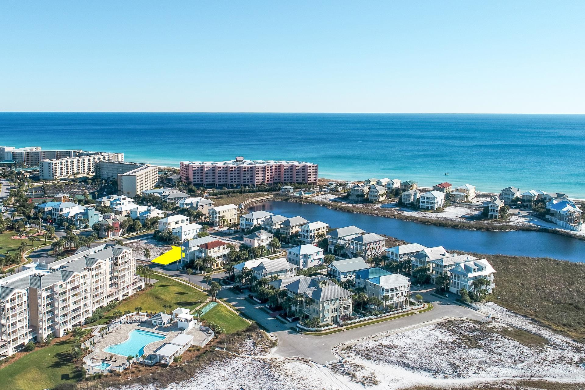 This large building lot is perfectly positioned next to many of Destin Pointe amenities. It's across from the large pool and shuffle board courts and a short walk to the tennis courts. You can stroll down to the jetties or take a quick walk to the gulf. There is a seasonal tram, so summer trips to the beach are even quicker and easier. This community is tucked away and allows you to enjoy Destin without any of the crowds. There are two pools, one gulf front and one across from this home. There is 24 hour security, lots of deeded beach, two lakes, shuffle board courts, tennis courts and sidewalks. You'll be able to see the fireworks over the harbor without leaving your subdivision.
