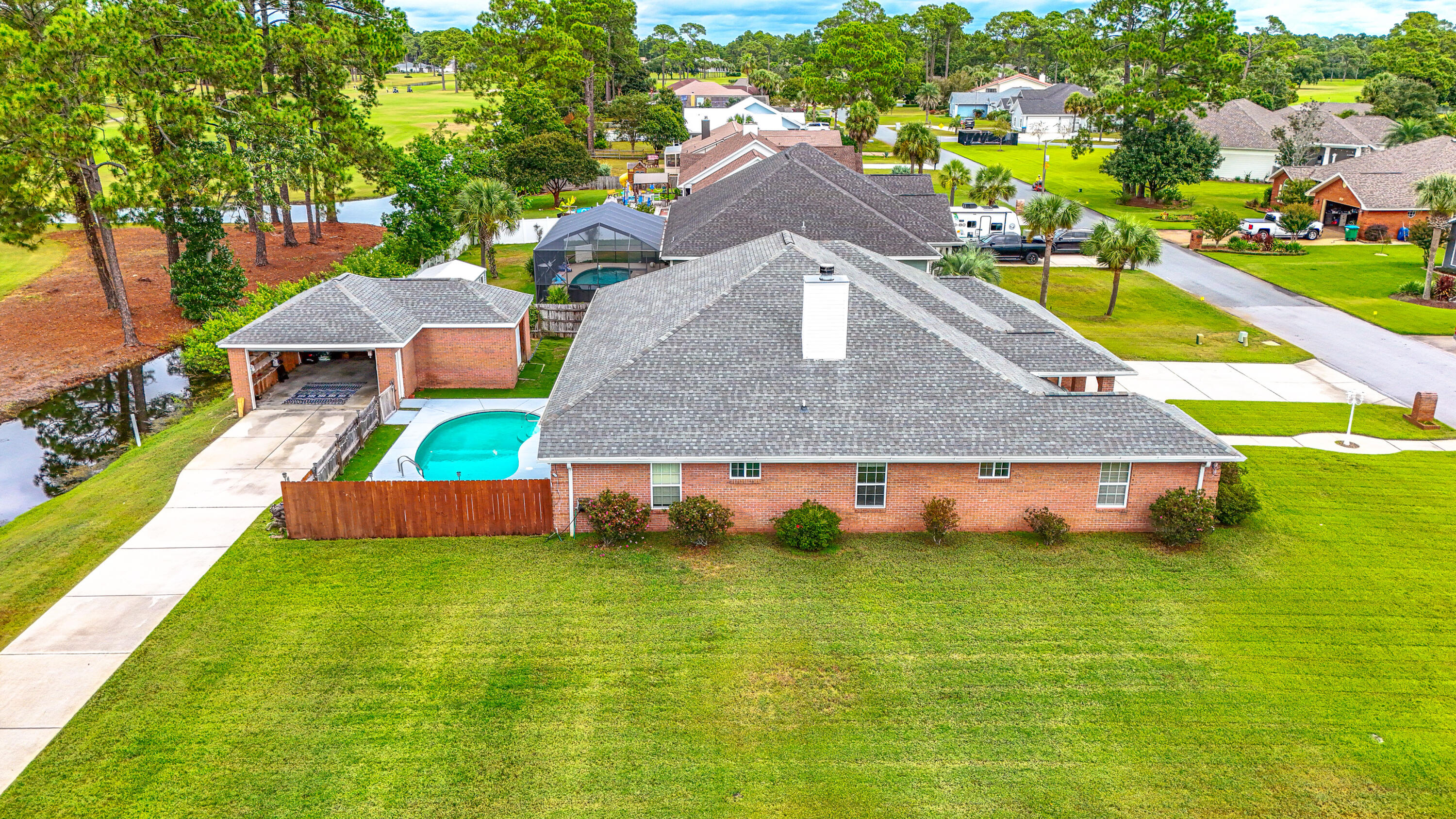 'CURRENTLY UNDER CONTRACT, SELLER WILL CONSIDER BACKUP OFFERS' 5-Bedroom Golf Course Home with Pool, Extra Garage, and No HOA! Welcome to 301 Eagle Drive, a one-of-a-kind custom built brick home located on a large oversized corner lot in the highly sought-after Colony Club community in Panama City Beach. This 5-bedroom, 3-bathroom home offers nearly 3,000 sq. ft. of living space with an open, light-filled layout designed for comfort and entertaining. And best of all—NO HOA! Step inside to soaring vaulted ceilings, abundant natural light, and a cozy fireplace in the main living room. The kitchen features granite countertops and a breakfast bar that flows seamlessly into the dining room and great room. Enjoy the spacious covered porch overlooking the private backyard oasis with an in-ground private pool, and plenty of room to relax or entertain. The oversized primary suite boasts a huge walk-in closet, a double vanity, and a large tiled shower with dual shower heads and a jetted garden tub. Additional living spaces include 4 additional bedrooms and a large utility room with washer/dryer. Car enthusiasts and hobbyists will love the attached 2-car garage plus an additional 3-car garage/workshop, along with ample parking for an RV or boat. Colony Club's prime location means you're just minutes from the sugar-white sands of the Gulf, Pier Park shopping and dining, Frank Brown Park, and the convenient Nautilus Street route to the airport. Outdoor enthusiasts will appreciate nearby Gayle's Trail, Conservation Park, and the community's Old Florida charm. Looking ahead, the planned Tallahassee Memorial Hospital and FSU Medical Research Campus promise long-term value for the area. If you're searching for a spacious, move-in-ready home with exceptional storage, outdoor living, and no HOA restrictions, this property truly checks all the boxes.
