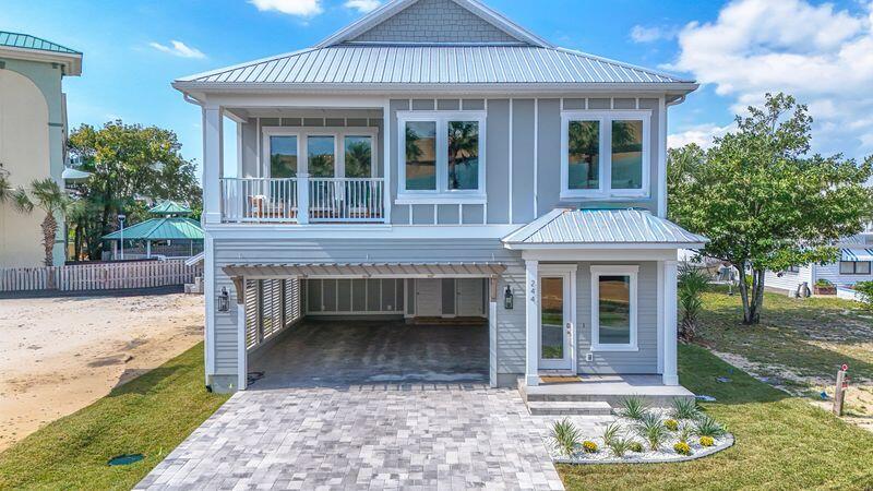 Exquisite New Construction Coastal Retreat - Fully Furnished
Discover this beautifully crafted coastal luxury home, located on the highly desirable West End of Panama City Beach, just steps from the Gulf's most beautiful beaches. Completed, fully furnished, and tastefully decorated, this residence offers both a serene retreat and exceptional income-producing potential.
This 5-bedroom, 4.5-bathroom home spans two stories with parking for 6 vehicles and designed for both comfort and sophistication. The chef's kitchen is a true showpiece, featuring upgraded stainless-steel appliances, including a French-door refrigerator, gas cooktop, dishwasher, wall oven/microwave combination, and washer/dryer. Custom 42' white shaker cabinetry, quartz countertops, and a spacious walk-in pantry complete this gourmet space. The open design flows seamlessly to outdoor living with a 12'x24' private saltwater pool, gas-heated for year-round enjoyment. Additional highlights include:

    "    Gas tankless water heater

    "    Hurricane-impact rated windows

    "    Durable metal roof & Hardie siding

    "    8' interior and exterior doors

    "    10' ceilings on both levels

A spacious game room offers views of the pool, while multiple living areas provide plenty of space for entertaining.
Conveniently located within walking distance to the pristine white-sand beaches, and just minutes to 30A, Pier Park shopping, dining, entertainment, and a short ride to local grocery stores, this home is the perfect blend of luxury and convenience.
\Whether as a private coastal escape or a high-yield vacation rental, this home presents a rare opportunity on the beautiful West end.