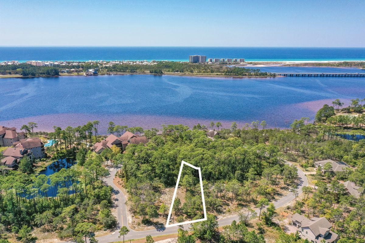 Build your dream home on this spacious home site close to all the amenities in the beautiful gated community of Wild Heron, a 734-acre Coastal Sanctuary, located on the shores of Lake Powell. This beautiful lot backs to a conservation area and is just a 3 min. walk or short bike ride to all the amenities on Lake Powell where you can kayak or paddle board to the World's Most Beautiful Beaches. Enjoy living on the quiet west end of Panama City Beach, with just a quick drive east to Pier Park or west over the bridge to 30A. Wild Heron is known for its world-class amenities including a lake view swimming pool, health & fitness center, ring fire pit, lakeside boardwalk and a revered oak-filled family park that features many types of fun filled family events. The lakefront boathouse and gathering place is well stocked with kayaks and canoes. A series of boardwalks and 24 miles of bike paths link the amenities for the convenience of all who call it home. Wild Heron is also the proud home of the Greg Norman designed Sharks Tooth Golf Course and hydro court tennis courts and can be enjoyed with a membership. Just minutes from world class shopping, dining, entertainment, 30A and the Beaches of South Walton, makes this home site an ideal location. Call today to start your future dream home. Buyer should verify all data and dimensions.