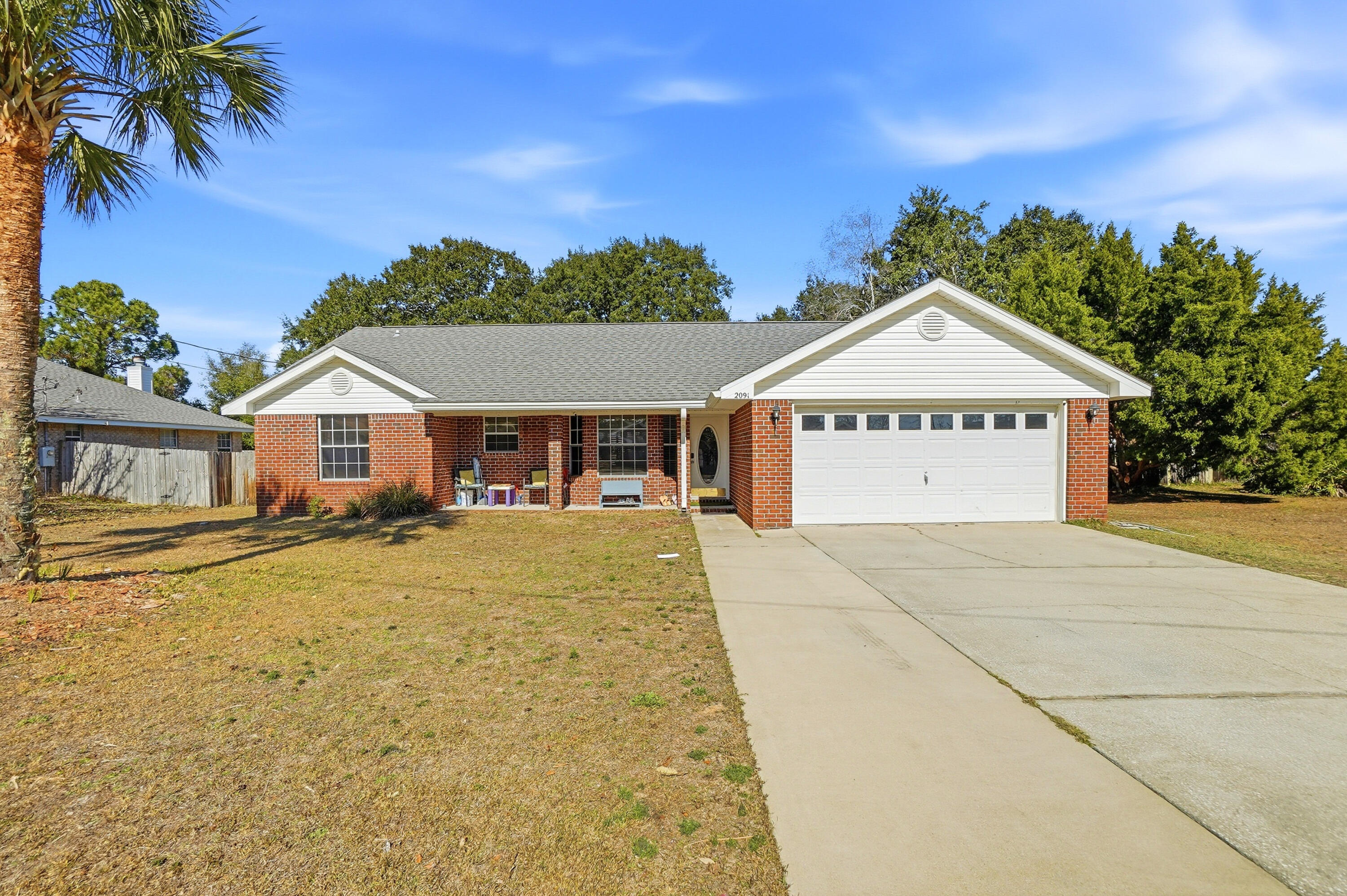 This beautiful brick home offers a comfortable, functional layout with vaulted ceilings, an open main living area, and a split bedroom floor plan that provides both flow and privacy. Natural light fills the living and dining spaces, creating a welcoming atmosphere for everyday living. This home features a 2.75% assumable VA loan for qualified buyers--an incredible advantage in today's rate environment and a rare chance to secure a significantly lower interest rate. The kitchen opens to the main living area and features stainless steel appliances, a breakfast bar, and a dining space accented by a bay window. The primary suite is spacious and includes dual vanities, a garden tub/shower combination, and a walk-in closet. Key system updates include an architectural shingle roof installed in 2020 (Atlas Pristine 50-Year Shingle), and water heater replaced in 2020, and a brand new HVAC system (interior and exterior) installed in June 2025, providing long-term value and peace of mind. Outside, the home offers a privacy-fenced backyard, full irrigation system, mature trees, and established landscaping deal for relaxing or entertaining. Conveniently located near schools, shopping, dining, beaches, and Hurlburt Field, this home delivers solid construction, reliable systems, and everyday comfort at an attractive price point.