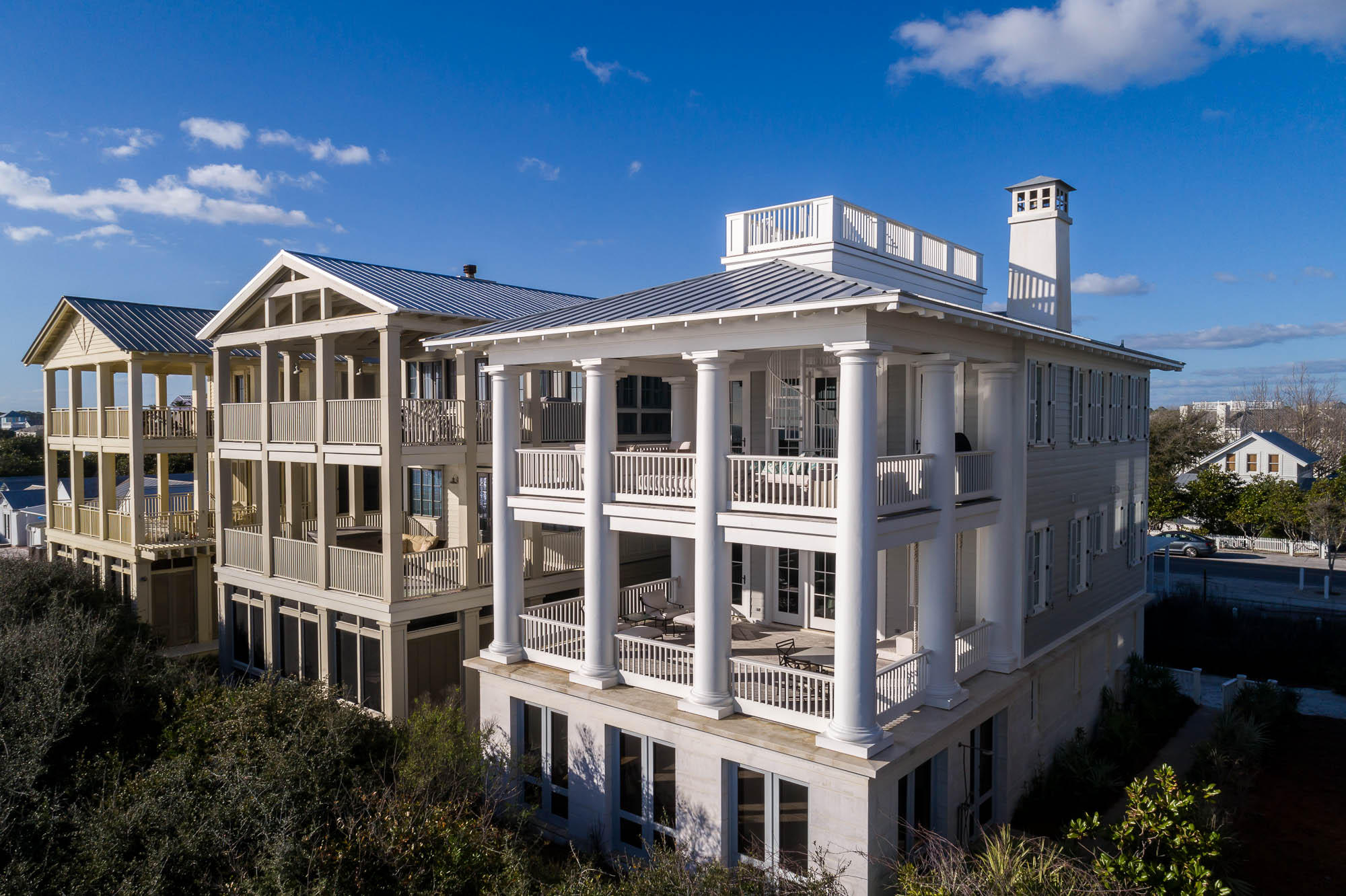 Designed by Don Copper, no detail has been overlooked in this fabulous gulf front cottage located in the heart of Seaside. Three 20'x 28' covered porches, one on each level, are additional living areas overlooking the gulf. Eight 20' tall columns surround the two upper porches. Epay wood imported from Africa was used on the porches and roof deck. Hand blown glass chandeliers hang from the foyer and at each landing as you climb the beautiful stairway. First level includes three guest bedrooms, 2 queen suites and bunk room with three sets of bunks. Each bedroom has its own private bath. Laundry also on first level. Stained wide plank wood floors give balance to the light colors of the interior finish. Dumb waiter services all floors for ease in transporting groceries and luggage. Two master suites with private baths are on the second level. One exquisite master suite features exposed beams, double vanity, steam shower and Jacuzzi tub overlooking the gulf. Private access from the master suite to one of the covered porch furnished with hanging bed, sofas and comfortable chairs with gulf views from east to west. Marble and glass tiles were used in all bathrooms. The third level you will find an open floor plan that encompasses the living, dining and kitchen area with vaulted ceilings and exposed beams. The kitchen is every cook's dream with granite countertops, Wolf gas stove with overhead hood, SubZero refrigerator, Dacor built-in microwave, 2 Fisher & Paykel dishwashers. In addition, there is a bar area with ice machine, sink, walk in pantry with SubZero wine cooler and half bath. The cooking island with bar accommodates seating for six and the dining table with banquette seats eight. Create a fire on crisp days in the wood burning fireplace. The mantle is made of 900 year old river cypress. For the finale a spiral staircase takes you to the widow's walk with uncompromised views of the Gulf of Mexico and all of Seaside. Relax and enjoy sun bathing on your private rooftop deck. There are amazing gulf views from all floors and the widow's walk.  Outside walls of first level are made of solid concrete block filled with poured concrete and rebar columns anchored 38 feet in ground. This property also includes a basement and a two car parking trellis. This is truly an exquisite property.