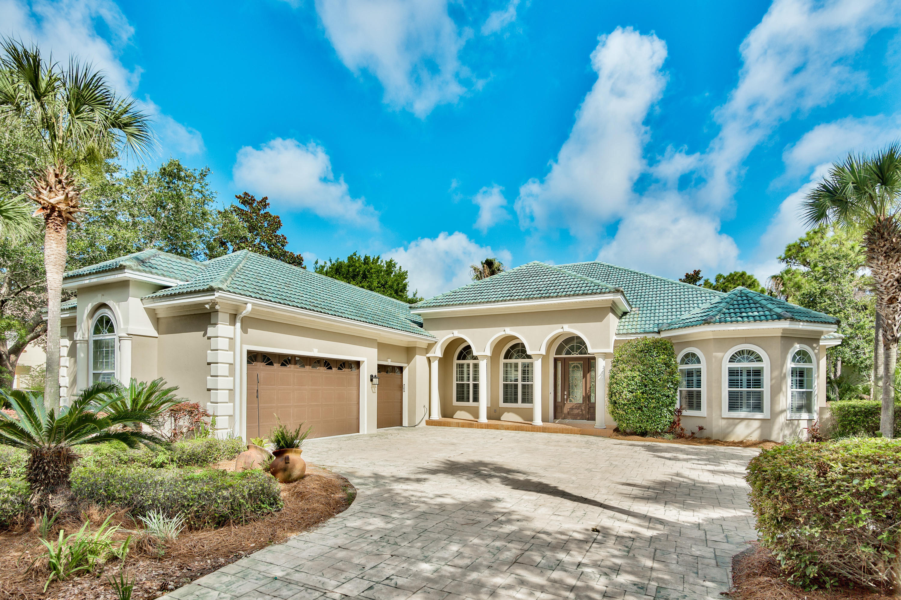 Stunning single story 3463 sq ft home on a lake with pool/spa on a large lot (.46 acres) in prestigious Regatta Bay. The home has three bedrooms all with their own baths, including a huge master suite with two walk in closets with built-ins, sitting area with fireplace, and an entrance to the outdoor living area. A nicely appointed study (which could be used as a fourth bedroom) with built-ins and closet is on the master wing of the house. The other two bedrooms are on the opposite side of the house. The outdoor living area has a large covered patio with a built-in kitchen area that opens to the deck of the pool/lanai. The open floor plan has a large family room and breakfast area off the kitchen, which has a double oven and granite countertops and a new travertine backsplash. From the front door, you walk into a large formal living and dining area, there is crown molding and fresh paint throughout the house.  The laundry room is oversized and there is a guest bath off the living room.  The oversize three car garage provides plenty of room for storage and a golf cart.   This house has all the features of other homes offered in Regatta Bay at a much more affordable price.  Recently installed new zoysia sod in the front yard will make this yard an envy! Buyer to verify square footage.
