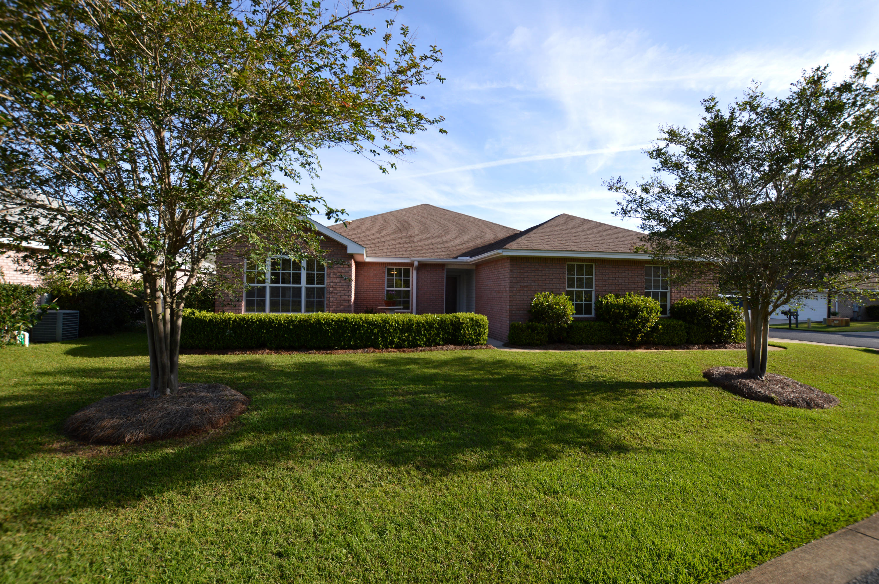 All brick well maintained home in Bayside. Corner lot and lush landscaping. Owner has taken meticulous care with home. Hardwood floors in dining and main living area and hallways, Tile in kitchen and baths. Wood look tile in laundry area. Eat in kitchen nook with kitchen island. Granite kitchen counter tops, full plantation blinds throughout home, carpet in bedrooms. Master bedroom has large walk in closet, master bath with double sinks, tub and separate shower and French doors that open up to the screen lanai. Gas fireplace, gas furnace and gas hot water heater, two car garage and immaculate. Bayside has a neighborhood pool, tennis, playground and Bayfront dock/park. Close to beaches and shopping. Owner has installed a stained glass front door and storm door.