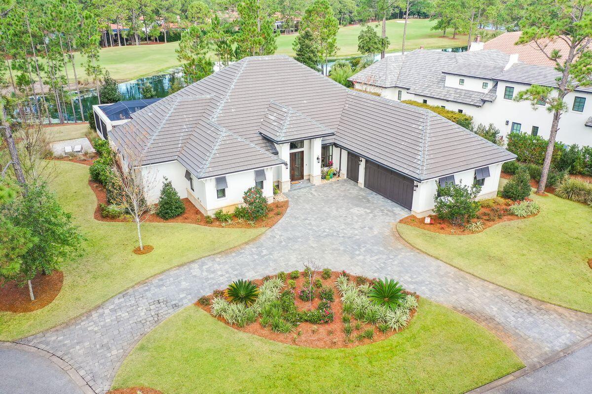 This stunning 4-bedroom lakefront home sits on the 5th hole of Sandestin's elite Raven Golf Club and will impress you from the moment you pull in the driveway.  Built by the local craftsman Doyle Owens, the attention to detail and designer level finishes easily separate this home from the rest on the market today.  This home can easily be described as ''Custom Elegance'', as no expense was spared.  One of the hardest decisions will be where to spend your time.  The interior is warm and welcoming, but the outdoor living is spectacular and includes beautiful lake and golf course views, a full outdoor kitchen with Cypress outdoor cabinetry, 3 TV's, speakers, fire pit, bar top dining, an oversized heated pool with jacuzzi, custom tile work, and so much more. A few of the numerous highlights on.. the interior of this remarkable home include custom designed walnut kitchen and entertainment cabinetry, a Chefs Kitchen featuring a Bertazzoni Master Series range/Bosch appliances, all bedrooms offer ensuite bathrooms with spacious closets, designer tile in all bathrooms with a cast iron tub in the Master Bath, custom-built bunk room, entertainment storage, Surround sound in all major areas, surveillance cameras, an oversized garage with storage space, room for 2 vehicles, and a golf cart, a water well for landscaping and so much more.  1521 Island Green sits in the back cul-de-sac of this peaceful non-rental community.  Call today to set up your chance to view this beautiful home that offers easy access to the top golf courses around and only a short golf cart ride away from the amazing shopping and restaurants in The Village at Baytowne Wharf.