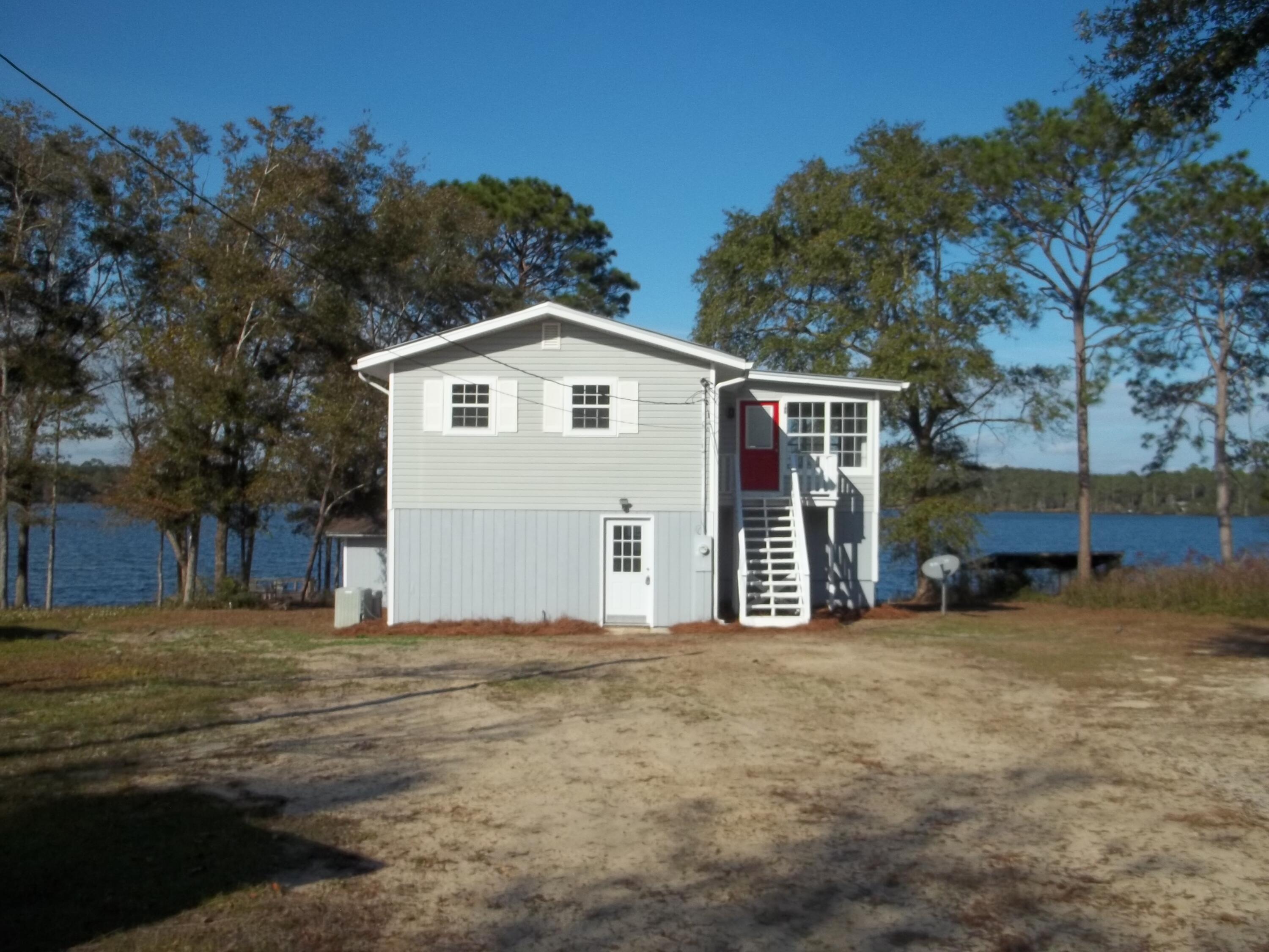Breath taking views from this nice unique home or from your very own dock on Lake Juniper.  2 bedrooms & 1 bath upstairs and 2 bedrooms & 1 bath downstairs. Home has new flooring, ceiling fans, appliances including a washer and dryer.  County site sates its 1508 sq ft. but with measuring the home it is about 2000 sq ft. Home is on public water but does have a private well (seller not sure of working condition).
All matters of importance should be verified by buyer.