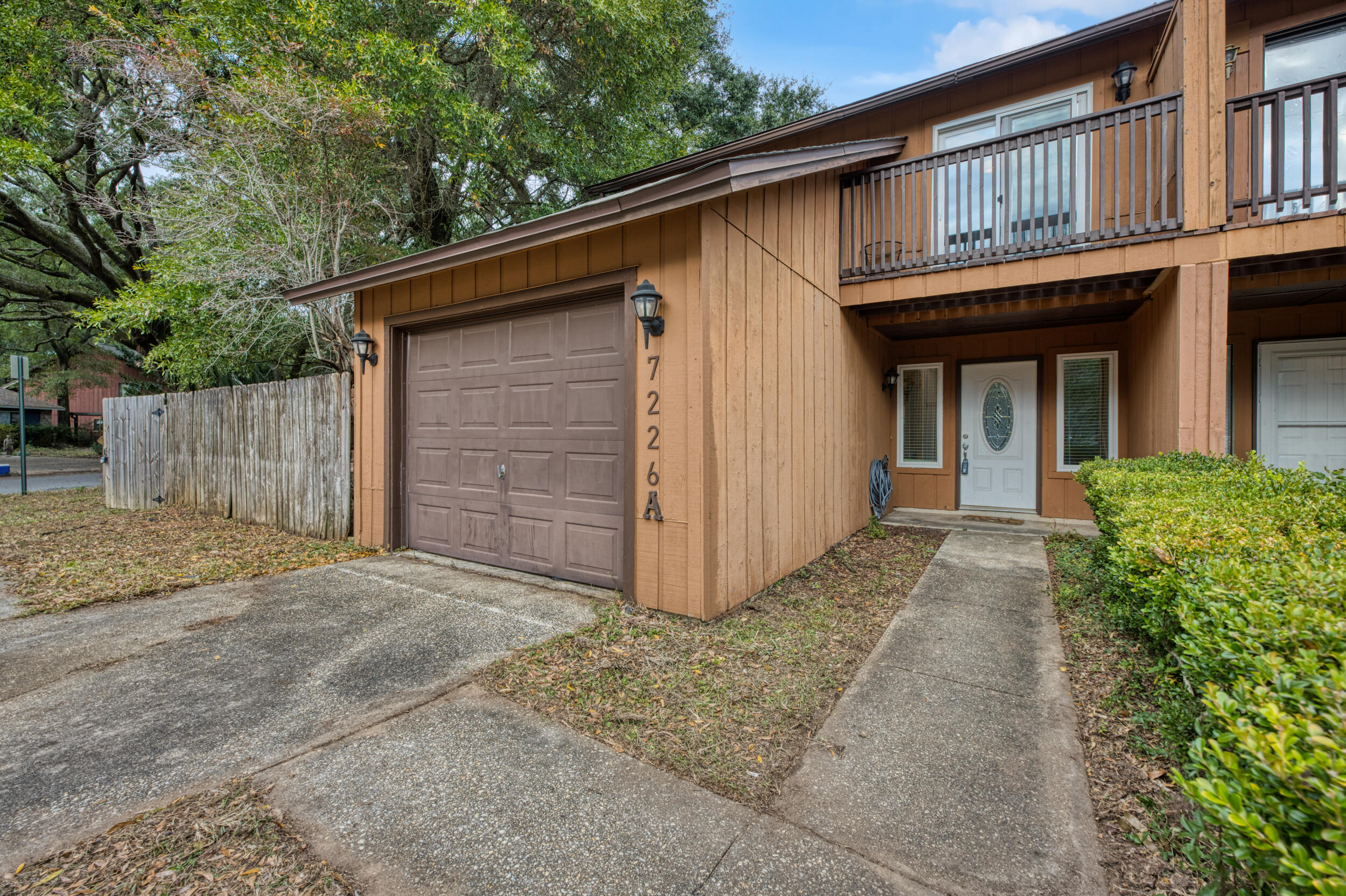 This well-located end-unit townhome offers comfort and convenience in the heart of Pensacola, just off Creighton Road and Scenic Heights. Surrounded by mature trees, the home features a large, fully fenced backyard that feels like a private retreat. Inside, the main level welcomes you with a cozy living room centered around a fireplace, creating a warm and inviting space. The adjacent kitchen and dining area offer easy flow and direct access to the back patio, ideal for outdoor meals. A convenient half bathroom on the main floor adds functionality for guests. Upstairs, all three bedrooms are thoughtfully arranged - the spacious primary suite stands out with a covered balcony overlooking the backyard, along with an en-suite bathroom featuring double vanities, a large walk-in closet, and a shared tub/shower combo. Additional highlights include all impact glass windows (replaced 2023), a one-car garage with washer and dryer hookups, a fully fenced backyard complete with a privacy fence, storage shed, plenty of parking, and double gate access to the backyard. With its central location, private outdoor space, and functional layout, this townhome is an excellent opportunity for first-time homebuyers or investors seeking rental potential in Pensacola!