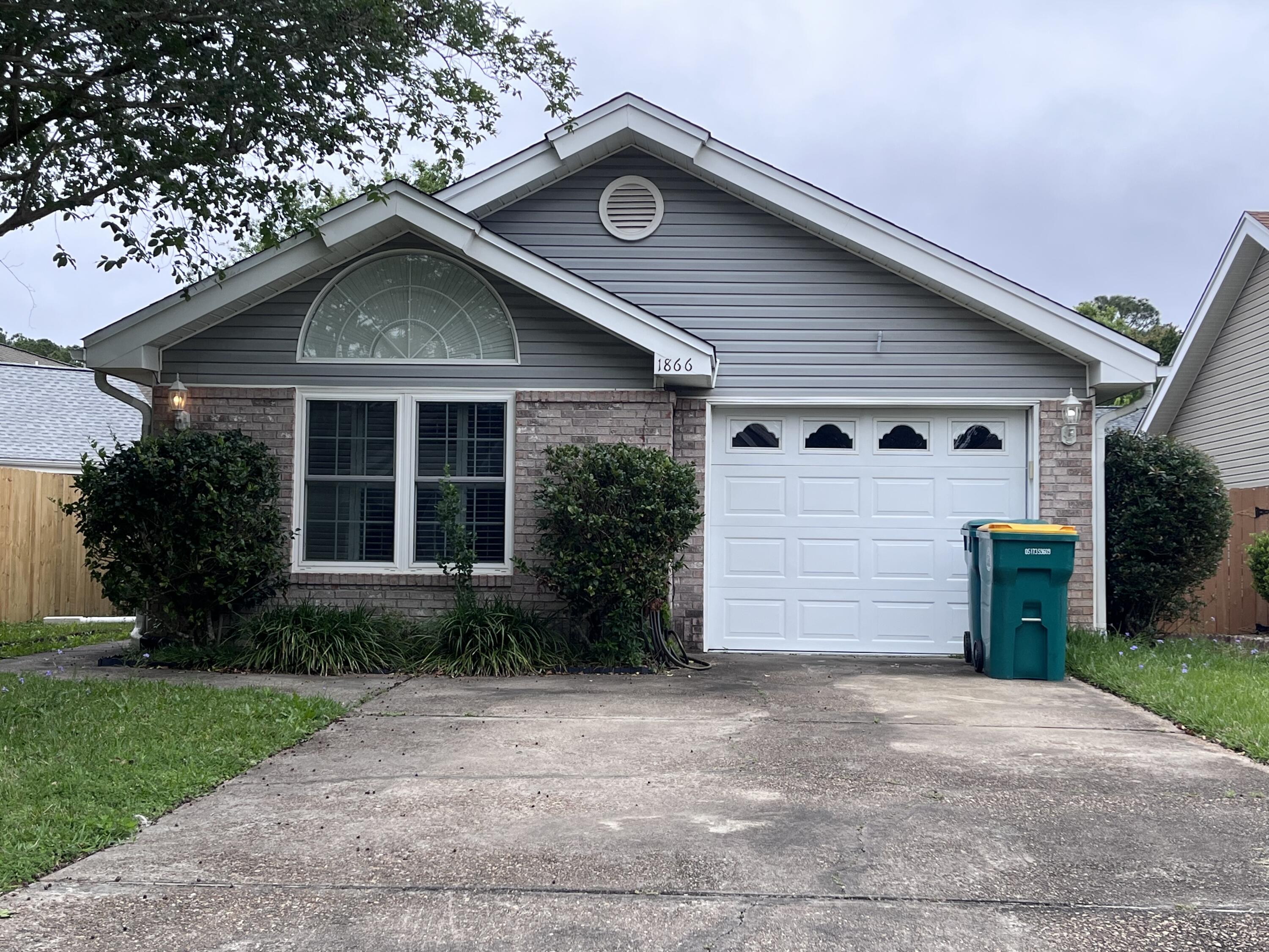 Beautiful home with a split bedroom plan, vaulted ceilings, a gas fireplace, carpet in the living room and dining area. Tiled kitchen with a breakfast bar. All bedrooms have wood flooring. French doors open up from the dining room to the back yard.