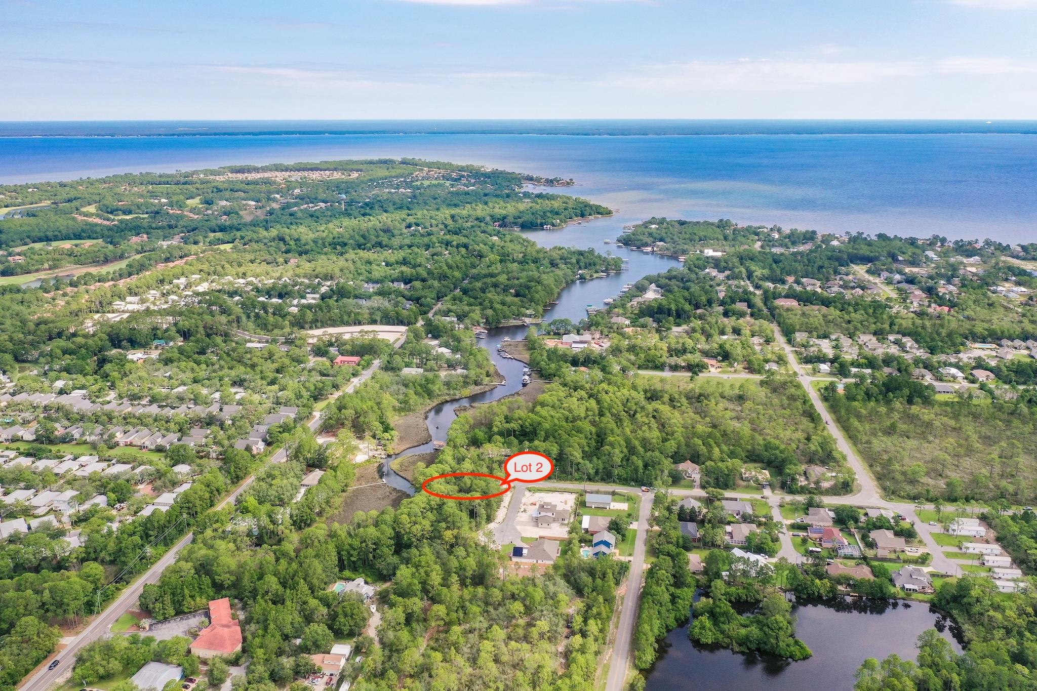 Large canal front lot leading out to the Bay in a brand new community! The developer's current plans are to have a community dock and fishing pier located just next to this lot! Conveniently located close to Grand Boulevard Shopping Center, restaurants, Sacred Heart Hospital, and just minutes to 30A as well as Miramar Beach. The beach is just a quick 5-10 minute drive. Tap fees have been paid and utilities are already in place. This lot will make for the perfect canal front new home. Come take a look! Buyer to verify all information contained herein.