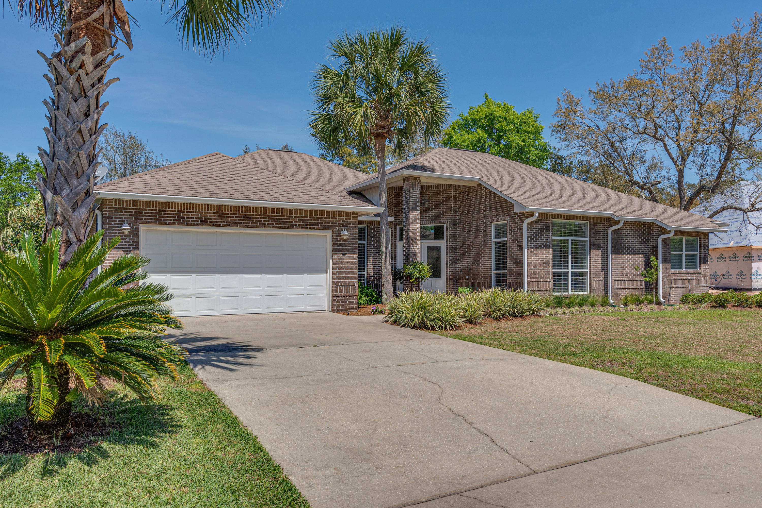 Located in The Estates at Hidden Creek in Navarre's highly desired Holley by the Sea community, this home is a new owner's dream. Just a short walk - or golf-cart ride - away from the club house and tucked away on a quiet street, you won't find a better property in Navarre. Inside you will find new gorgeous porcelain tile in the living areas and new carpet in all of the bedrooms. The owner's have spared no expense when it comes to loving this home: the tubs and showers have been resurfaced, matching high-end Kitchen Aid appliances are in the kitchen, a new HVAC unit in 2018, and a keyless entry and Ring system on the front door. Out back find yourself located on Hidden Creek golf course with beautiful shading oaks. There's even a fenced-in dog run! New roof to be installed April 2020