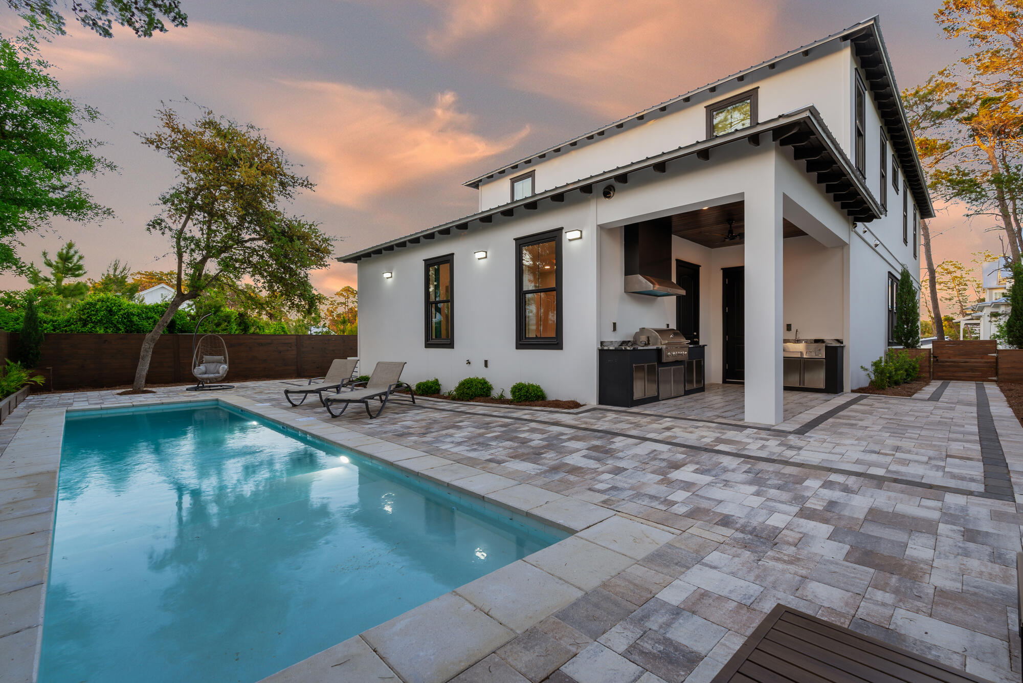 HEATED SALTWATER POOL!! Step inside this newly constructed 4-bedroom, 3.5-bath coastal residence, where meticulous attention to detail and the finest materials have converged to create an exceptional living space. The open floorplan with 10' ceilings greets you as you enter. The heart of this home, the open kitchen and living room, is designed for both gourmet cooking and entertaining. The kitchen is a masterpiece of practicality and aesthetics, with marble countertops, a professional-grade gas range, high-end KitchenAid appliances, and a captivating stone backsplash. The first-floor master suite redefines luxury, featuring double sinks, a custom-tiled shower, and a stone soaking tub, offering the ultimate space for relaxation.