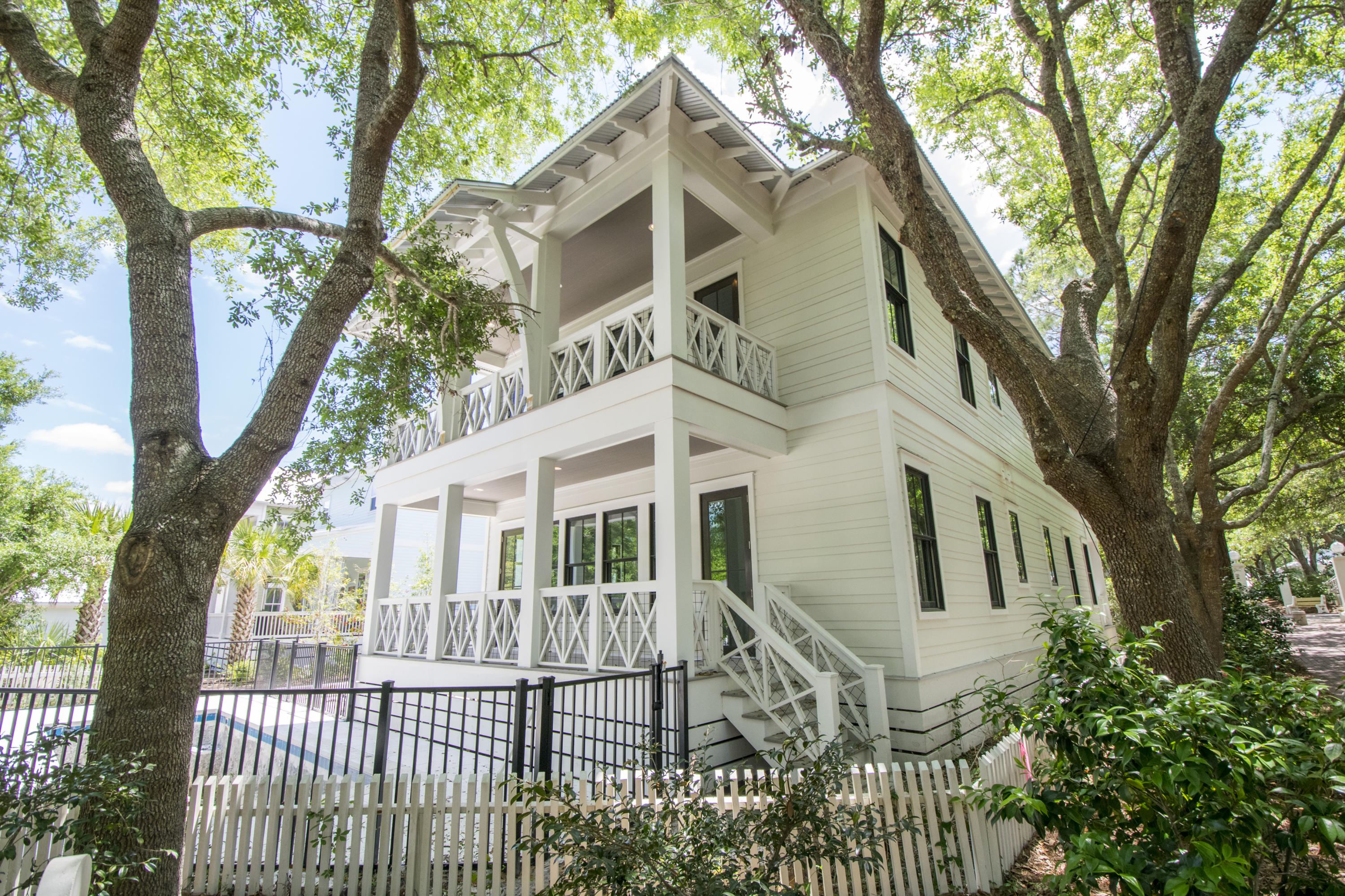 Nestled in among the trees is a magnificent gem with beauty and character awaiting its new owner. Entering notice the real wood floors with the exceptional lighting that adorns the living room area. All stainless steel appliances with white marble has your kitchen complete. As you continue on the main floor you will approach a first-floor ''Pool Den'' and master bedroom. 2nd floor includes three bedrooms plus a custom-designed bunk room. 3rd floor has room for an office, additional living area or game room. Beautiful ship lap covers the interior and leads to a wonderful pool area. Lots of shade with close proximity to the beach. You must see to appreciate.