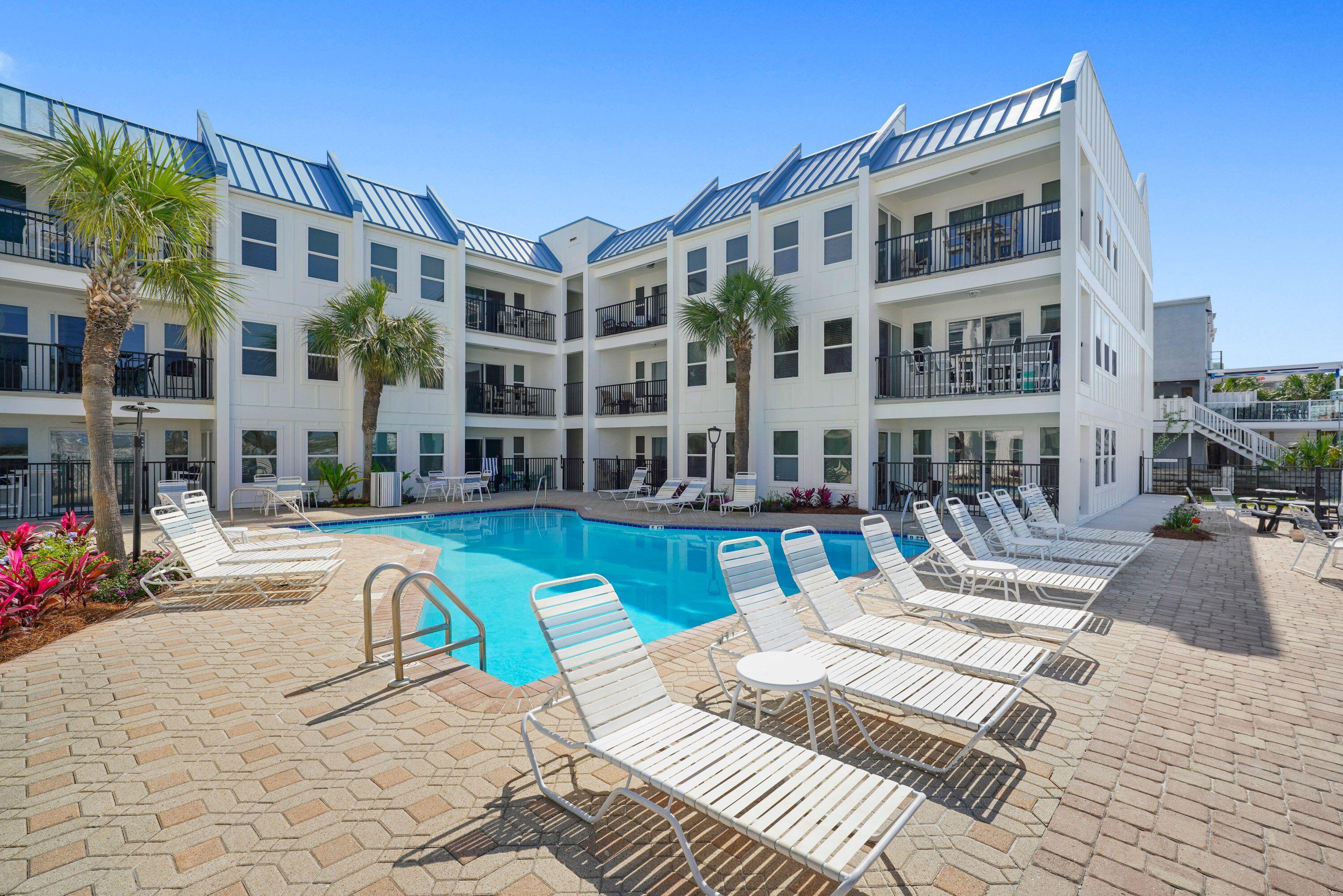 PRICED TO SELL! Your 'Piece of Paradise' awaits you on desirable Holiday Isle! This ground floor, end 2BR/2BTH unit features updated floors, newer appliances, newer HVAC, porcelain tiles in guest bath, quartz tile floor in master bath, laundry in unit. Catch a glimpse of the Gulf from your kitchen window or dip your toes in the Emerald waters! The beach access is just steps from your door and a short stroll out to the sugary white sand beaches! Poolside Villas is a gated complex with only 30 units giving it a secluded feel, yet convenient to Harborwalk Village, fine dining, fishing, breathtaking sunsets, all the very BEST of DESTIN! It offers a large pool, grilling area and ample parking. Unit #103 has been well loved and maintained as a primary home, is being sold unfurnished, ready to create your own coastal retreat! The building has recently undergone a beautiful $2M exterior renovation, making it sparkle like new and will make a perfect primary, vacation or investment home with projected rental income of $32K-$45K! Special assessment has been 'paid in full' and the building meets the state milestone inspections. A MUST SEE!