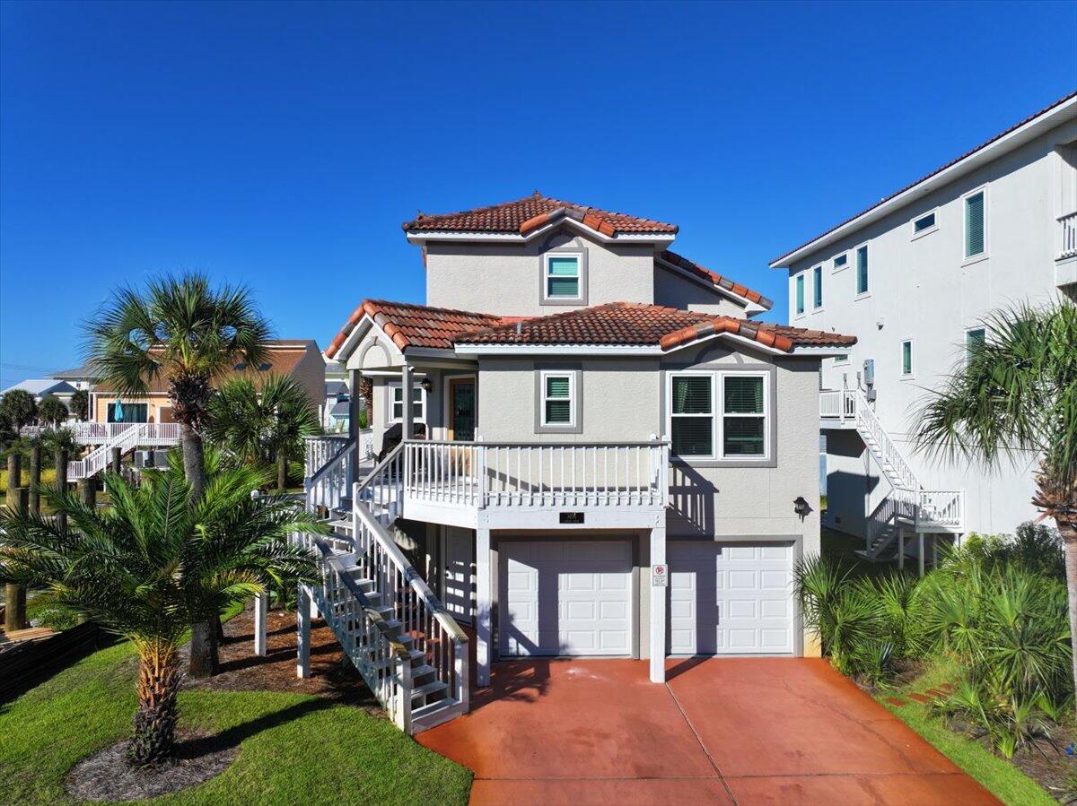 This is the Florida Beach House of your dreams! 350 feet from Gulf of Mexico Beach access, WATERFRONT community!  Water access everywhere including a dedicated walk way to the Santa Rosa Sound!  If the beach is calling you, look no further!  This cozy home features a remodeled kitchen and bathrooms, new windows, garage doors, appliances,  lighting, etc.  Great attention to detail and care were given in the remodel of this home.Just steps away from the warm waters of the Sound and a short walk to restaurants, shops, and of course the sugary-white sand of the Gulf of Mexico. The community pool is also right across the street. This affordable beach home features 3 large bedrooms that each have full bathrooms attached. The wrap around porch is perfect for sitting outside enjoying the breezes.  Downstairs is a porch area for barbecuing and entertaining.  Also a space inside the garage area has been converted for an office/small home gym which is heated and cooled.
