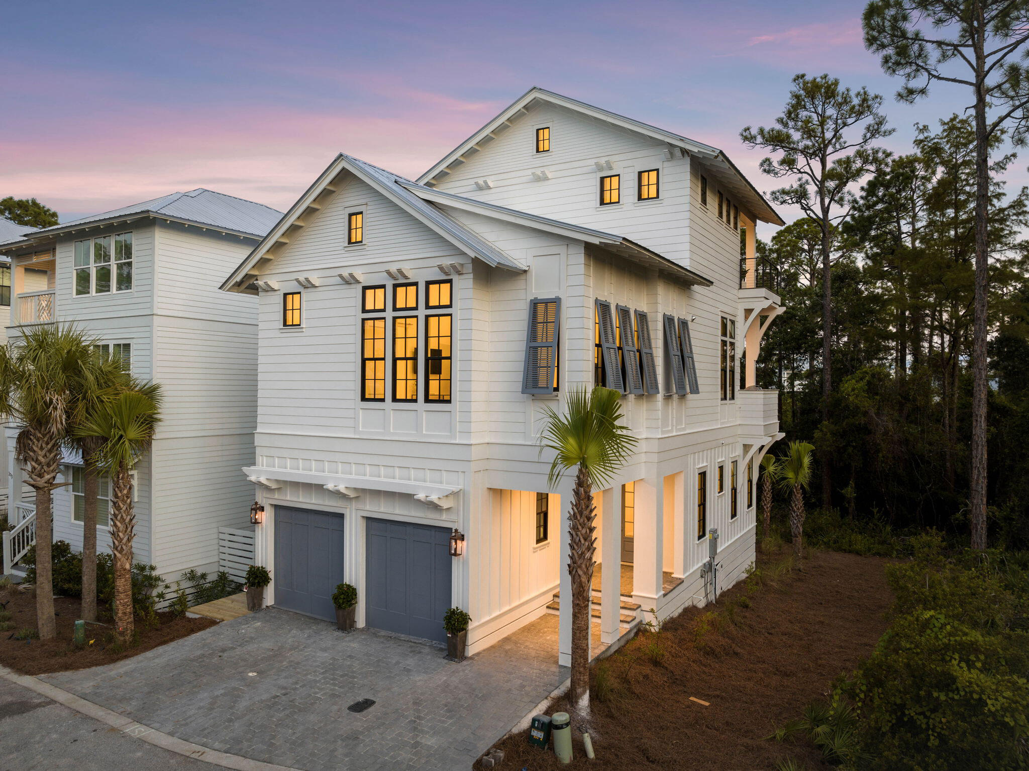 Step into a beautifully crafted new construction home, designed by Gregory Jazayeri and built by Focus Construction, nestled in the exclusive Treetops neighborhood of Inlet Beach. This 2,553 square foot residence seamlessly blends luxury and function across three thoughtfully designed levels, all set within a gated community with direct beach access and a community pool.

As you enter, you'll be welcomed by the warmth of European hardwood floors and the sophistication of cypress accent ceilings, which complement the expansive 10-foot ceilings on the first floor. The second floor soars to 12 feet, creating an airy, open space perfect for entertaining or unwinding.

The heart of the home is the gourmet kitchen, featuring Thermador appliances, custom cabinets, and a large island with a stunning waterfall edge. The kitchen's sleek design is further enhanced by a tiled backsplash that extends to the ceiling and black accent hardware, giving it a timeless appeal. Just off the kitchen, an outdoor BBQ summer kitchen awaits on the second-floor terrace, ideal for al fresco dining amidst the tranquil surroundings.

Natural light floods the home through large windows, illuminating every corner and highlighting the meticulous craftsmanship, including custom hand-fabricated interior and exterior handrailings. Each of the spacious bedrooms boasts ensuite bathrooms, floating vanities with under-cabinet lighting, and large walk-in closets with custom shelving. The bathrooms are a true highlight, featuring hand-selected tile and frameless glass door showers, offering a spa-like retreat.

The primary suite offers a serene retreat with views of the lush nature preserve and access to a private balcony, providing a peaceful backdrop to start and end your day. Solid core doors throughout the home ensure privacy and quiet, while the epoxy-coated garage floor adds a polished touch. Outdoor gas lanterns and landscape lighting enhance both the beauty and security of this well-appointed residence.

Every detail in this home has been carefully curated to offer the perfect blend of luxury and lifestyle. With beach access just moments away and the privacy of a gated community, 411 Redbud Lane is more than just a homeit's a coastal sanctuary.