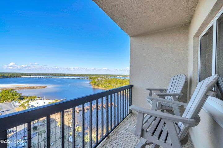 Completely remodeled from the studs out, this sleek, modern Pinnacle Port Penthouse one-bedroom residence offers extraordinary front-to-back Gulf Front and Lake Powell views. Unique to this tower floorplan, the bedroom and primary bath are located on the first level, while the second level features the kitchen, dining/sitting area, powder room, laundry, and a Gulf-front living room with balcony, creating ideal separation of space and dramatic elevated views. The Gulf-front primary suite includes an inset TV nook and a spa-inspired bath featuring a Swiss Madison commode, frameless walk-in shower, live-edge wood vanity, and vessel sink.
