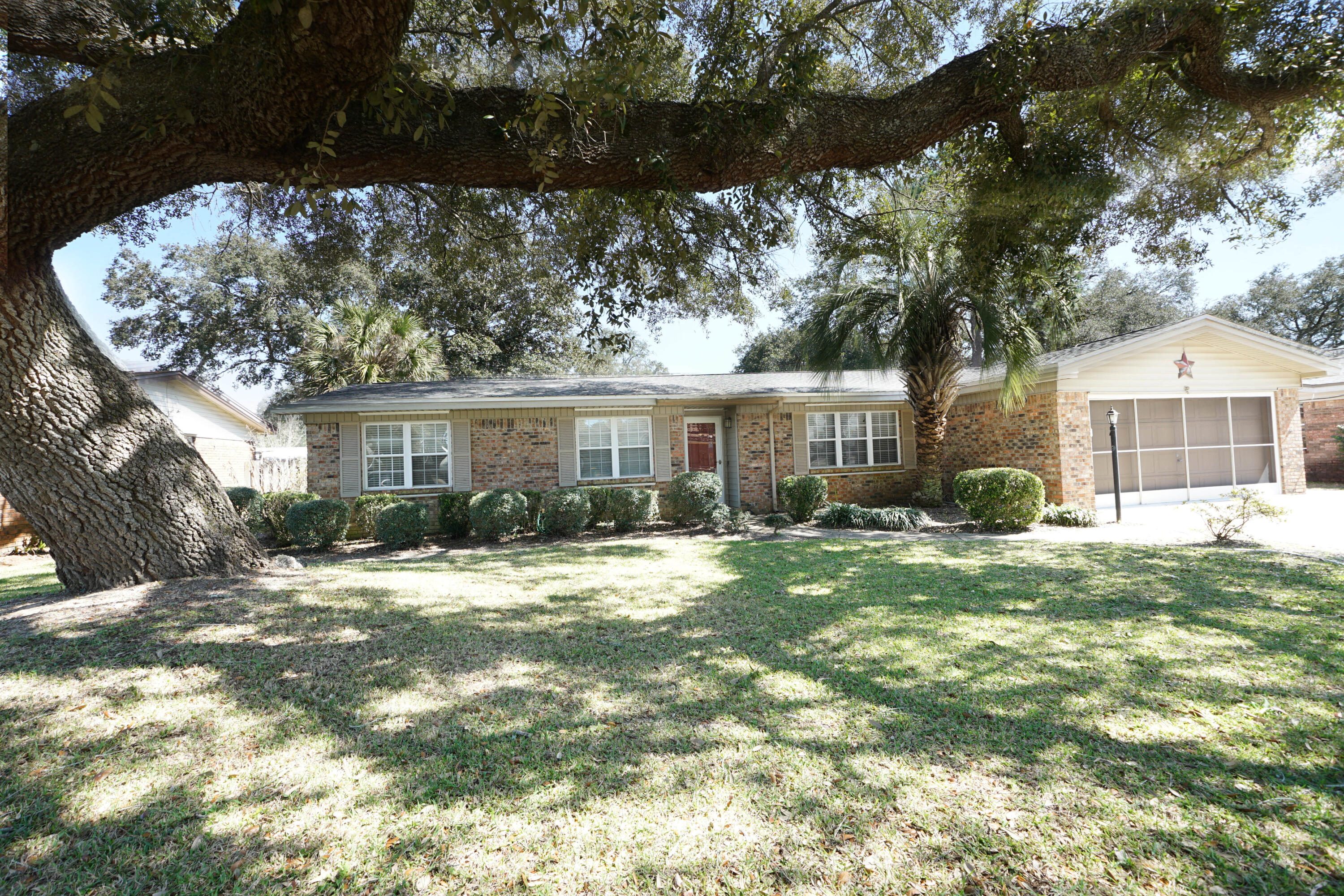 Charming, Warm and Elegant! A hidden treasure conveniently located in the heart of Niceville that offers you walking distance to grocery stores, restaurants, middle school and high school making it perfect for anyone concerned about convenience.   This home features 3 bedrooms and 2 baths.  The premium to this home is not only its location but its livable floor plan that lives bigger than square footage and the luxury of expanding your entertainment to your in-ground pool is perfect for any lifestyle.  This privacy fenced backyard is perfect for any entertainment to include a screened porch perfect for those weekend grilling or fellowship gathering.  What makes this home stand out from the others is the fact it has 2 living areas giving you many options to accommodate any lifestyle with 3 3 bedrooms.  Kitchen adjacent to the family room allowing time together......Home is light and bright with plenty cabinets in kitchen for any chef.  No detail has been overlooked in this house just waiting to become your home.  
The Screen in the garage is fantastic for the garage.  Perfect for working or for those little ones who love to ride their cars.....or just playing.......