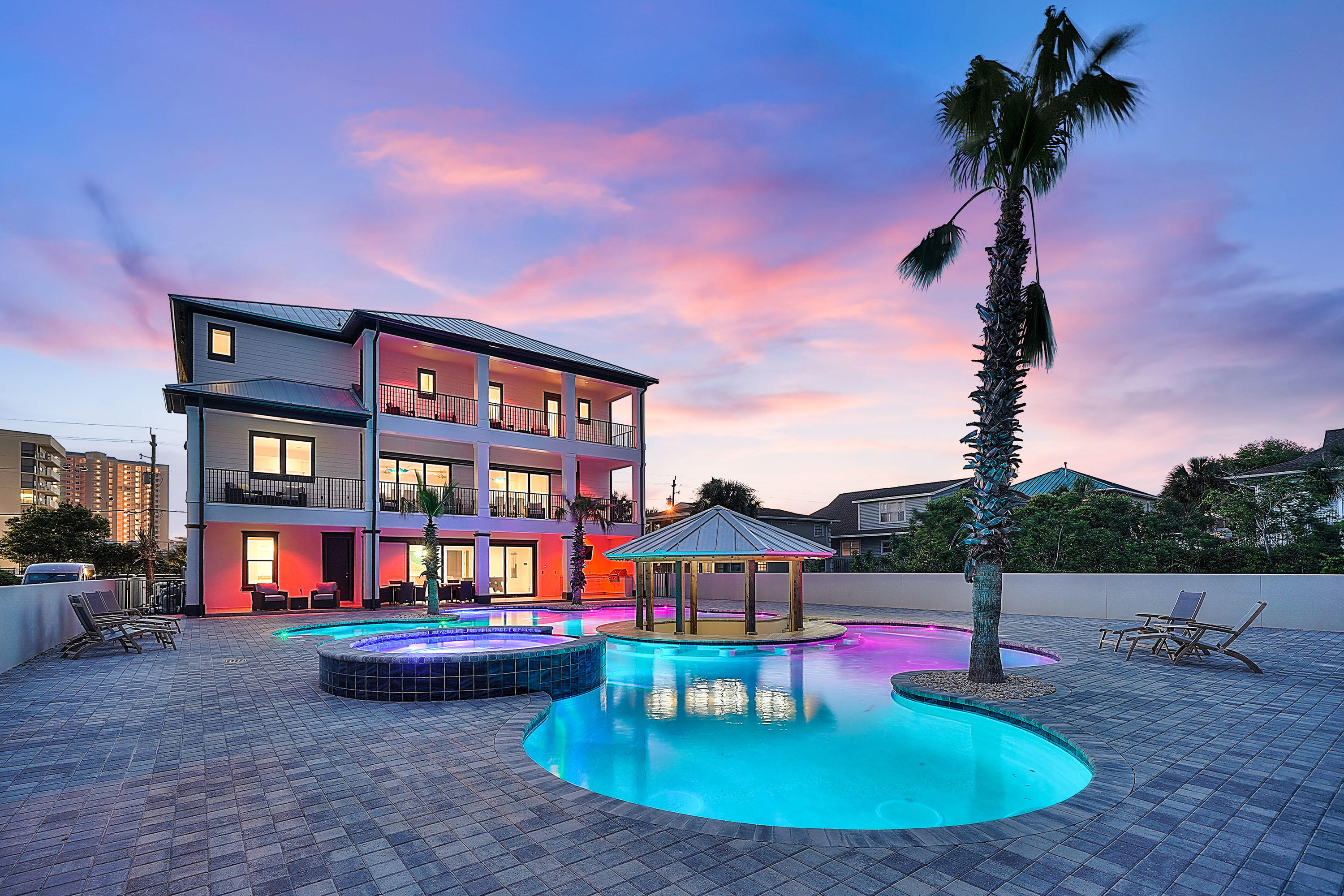 Set to top $290K in annual gross rental income for 2021 this, newly built rental machine checks all the performance boxes - gulf views, short walk to the sand, resort-style pool, spacious gathering spaces.  Stunning design, state-of-the-art amenities, and extraordinary Gulf views create the ultimate in beachside allure in this newly constructed home in Miramar Beach. This 2019-built, 5,688-square-foot home features a designer kitchen, luxurious resort-style pool, and game room. Each space is carefully curated for exceptional living and entertaining. White walls, clean lines, and coastal materials punctuated with sea-inspired hues make the rooms feel relaxed and airy while highlighting the natural beauty outside. A resort-style pool with sunk-in bench seating and swim-up cabana, hot tub, covered alfresco dining,  summer kitchen elevate the backyard to a gorgeous open-air oasis. 
The kitchen is impeccably designed to gather and entertain with a large center island with seating for six, a 6-burner Wolf range, quartz counters, a farmhouse sink, and seamless flow into the formal dining room. The entertainment room features a wet bar with seating, a pool table, and immediate access to the pool. All 8 bedrooms and 8.5 baths are design-forward with modern-coastal finishes. This private retreat is just steps from the beach and is presently one of the most luxurious private homes in the area.