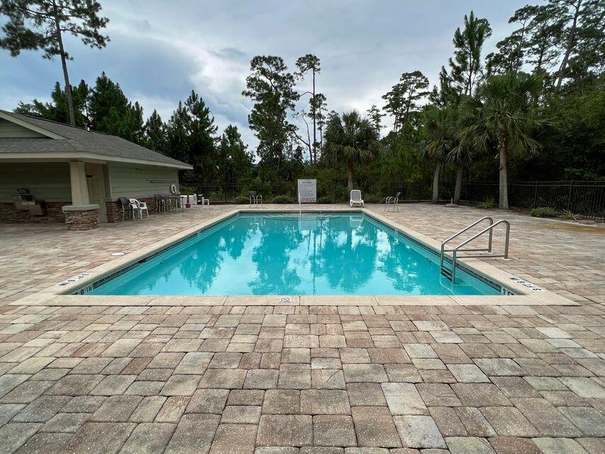 Former Model END unit in Sound Haven;   Community located just 3 miles west of the Navarre Beach Bridge. Development includes community pool and beach access on the Santa Rosa Sound. Former Model home has 3 bedrooms 2.5 bath townhomes with garage and extra long driveway! This craftsman style unit features unbelievable attention to detail, from the stacked stone accents on the exterior, to the tile floors on the first floor, granite countertops in the kitchen and bathrooms, beautiful designer cabinetry, upgrade fixtures, nothing was overlooked. Kitchen equipped with all stainless steel appliances including refrigerator. Living area is open to kitchen and has lots of light; Washer and Dryer included. Large Bedrooms are upstairs separate from the Living area; Bedrooms Molding added, large 21" tile, AND impact windows that the newer units do not include! Bedrooms have carpet, beautiful tile downstairs; Beautiful rock entry on Front Porch with Rock Columns; Small patio outside back area for relaxing! Great location, close to schools, beaches, and military bases:  Schedule your private showing today!