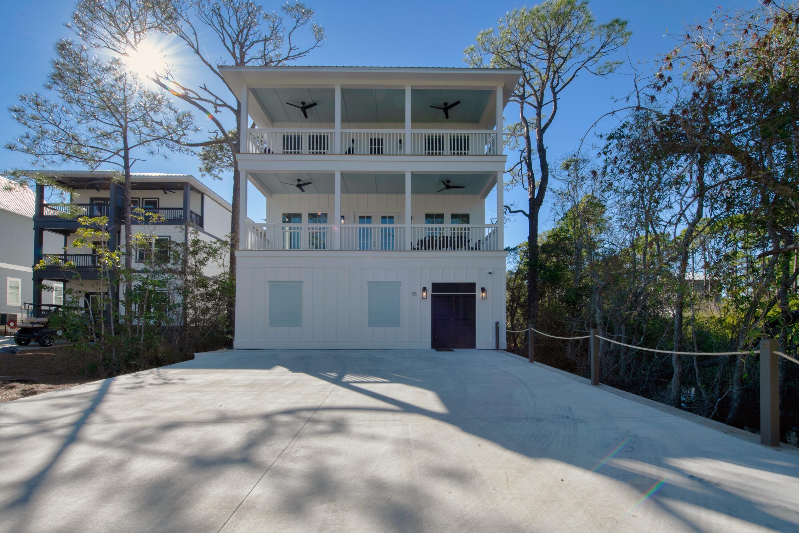 Beautiful custom built home completed in 12/ 2020 is rental ready!  As you enter the gate on the ground floor,  you are greeted with an in-ground gas heated swimming pool. This home has 5 bedrooms and 6 1/2 baths.  Pre-engineered hardwood flooring throughout the second and third floors.  All bedrooms have their own bathrooms and there is a 1/2 bath on the second floor just off the dining area.  Second floor consists of gourmet kitchen,  living room,  dining area, 2 1/2 baths and 2 bedrooms.  The kitchen  has stainless steel appliances, with a 6 burner gas stove, custom tile backsplash, plenty of cabinets for storage, quartz countertops in kitchen and all bathrooms vanities.  All bathrooms have tiled flooring and tile surrounds. The third floor has 3 bedrooms, 4 full baths & family room.   The master bathroom has a large walk-in shower with double shower heads and a soaking tub. Never run out of hot water with the gas rinnai.   Both floors have a large deck 9' deep and 30' wide and the 3rd floor deck has a gulf view.     Just a short walk to the public and walking distance or bike riding to restaurants and shopping.  This neighborhood has no HOA fees.  There is a security camera in place