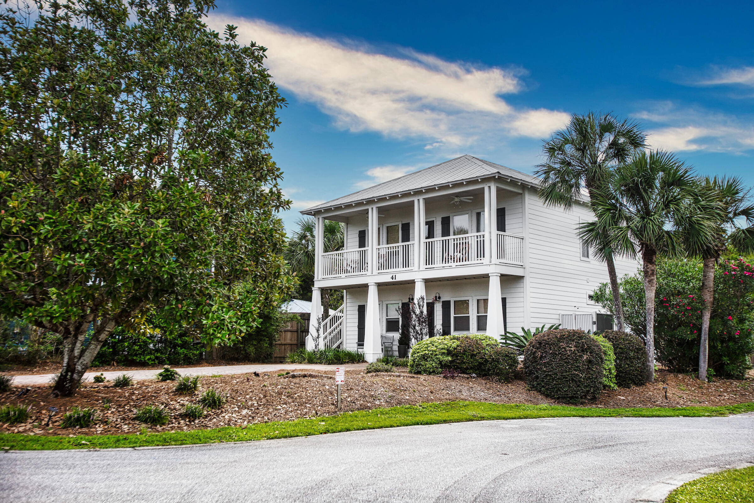 The quaint neighborhood of Tranquil Shores is ideally located in Seacrest Beach. Only about 200 steps to the beach access, a mile to Alys Beach and less than 2 miles to Rosemary! All the shopping, dining, and entertainment is a quick bike or golf cart ride away. This beautiful coastal home has LVP flooring both upstairs and down and tile in the bathrooms. The large living/kitchen area are on the 2nd floor. 2 master bedrooms, one up, one down. Upstairs master bath has 2 separate vanities, large walk-in shower, huge walk-in closet and owners closet.  The first floor has another master bedroom, and 2 additional bedrooms, one with built in bunks. Laundry room is on the first floor which is convenient after a day at the beach. The large covered side patio is perfect for entertaining.