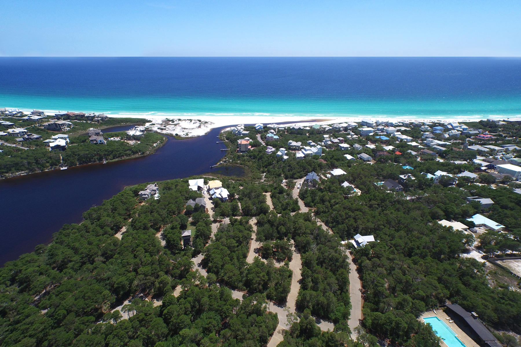Located in the west peninsula of Draper Lake Coastal Village, this corner lot backs up to a scenic path leading directly to the pedestrian bridge over Draper Lake. It offers exceptional privacy with only one neighbor. Set so close to the bridge, neighborhood amenities on either gated peninsula are within easy reach. Closest is the 40-foot observation tower capturing panoramic views that include the emerald waters of the Gulf of Mexico. Owners may keep their paddle boards at one of two boat houses on Draper Lake, providing access to its placid brackish waters. Adventure to the outflow of the lake which occasionally breaches the white sand beach to meet the gulf. Just over a quarter mile down a neighborhood street is a private rest facility with golf cart parking, reserved exclusively for Draper Lake owners, just yards away from beach access.